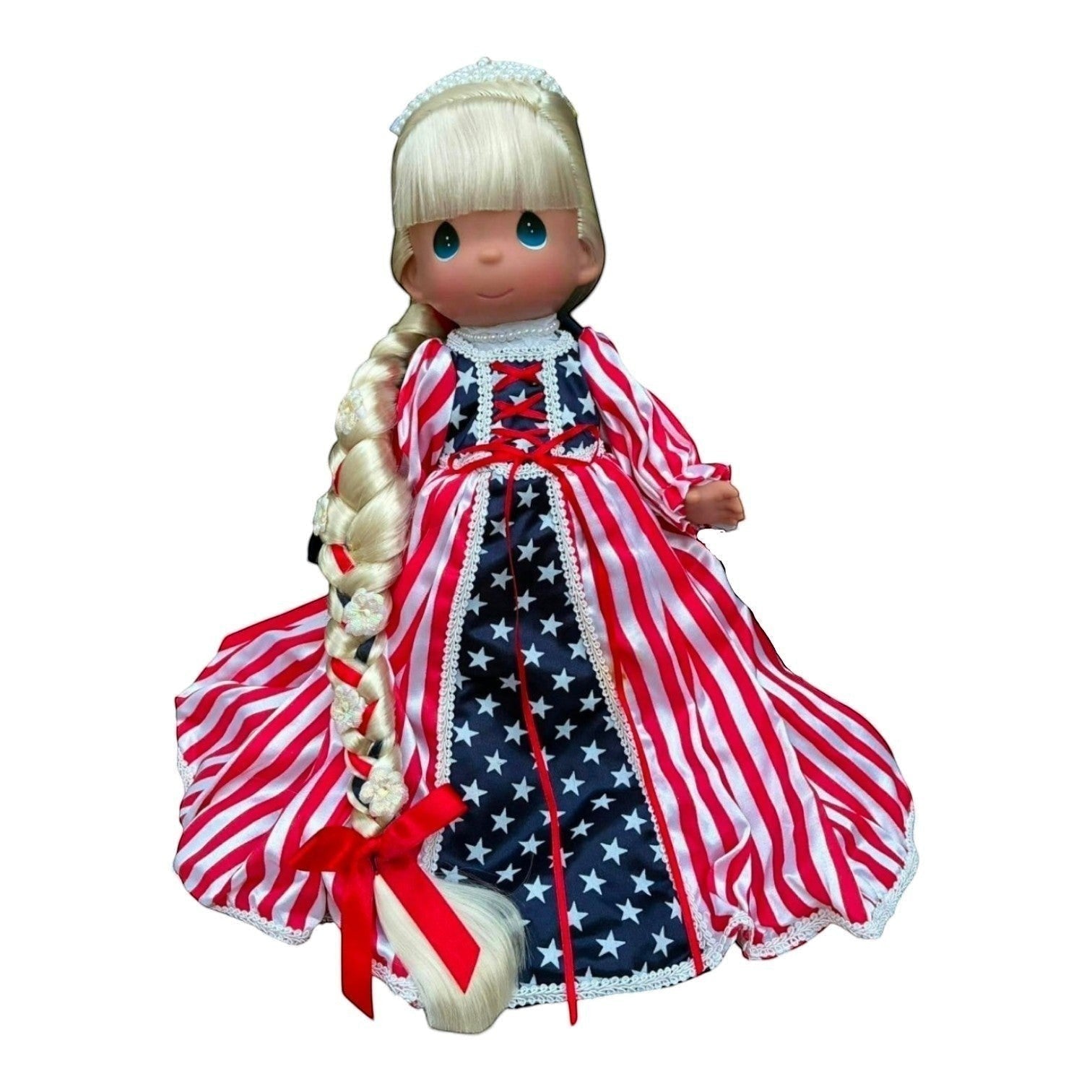 The Doll Maker 12-inch Patriotic Rapunzel doll with long blonde braid and red, white, and blue star-striped gown.