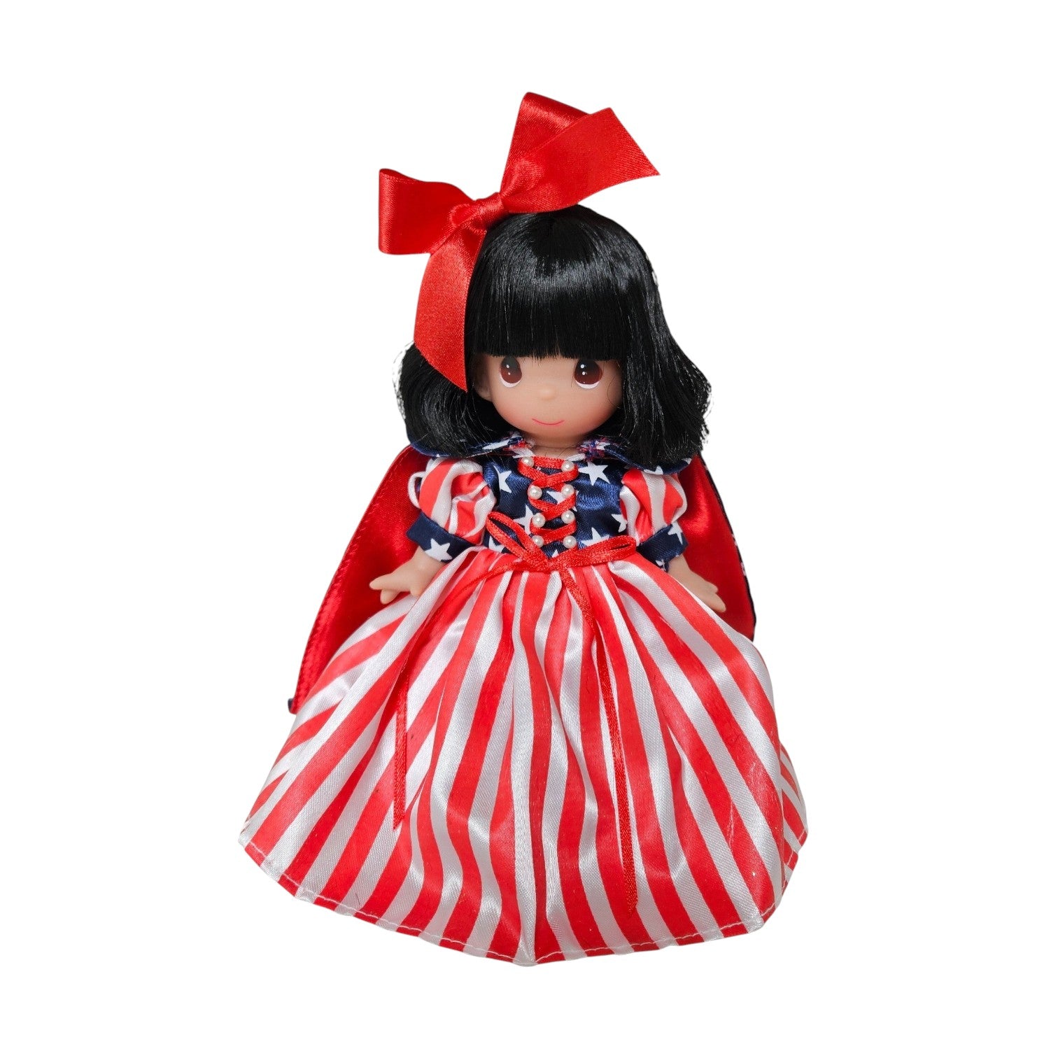 The Doll Maker Patriotic Snow White 7-inch vinyl doll wearing a red, white, and blue star-striped dress with a red bow.