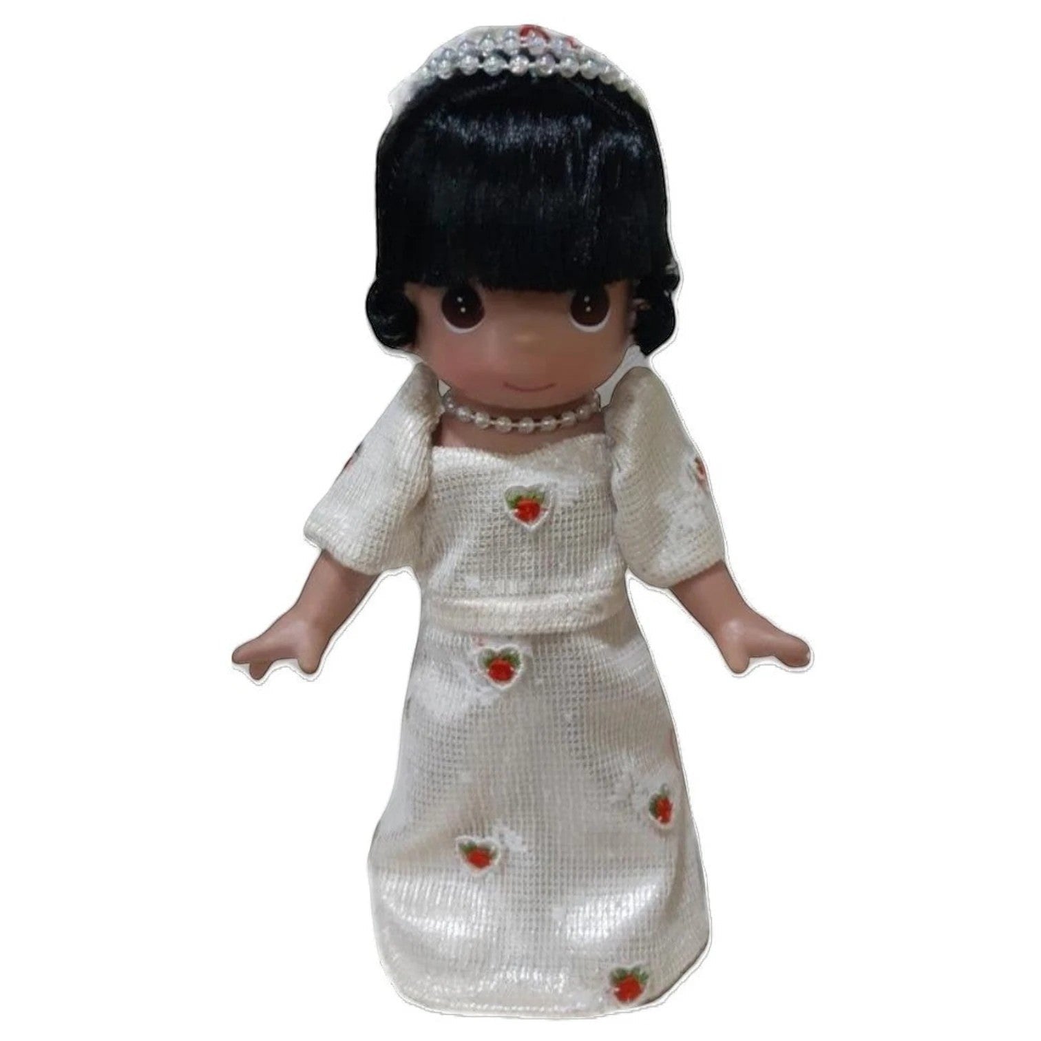 The Doll Maker 9-inch Rosalio doll from the Philippines wearing a white dress and beautiful hair accessories.