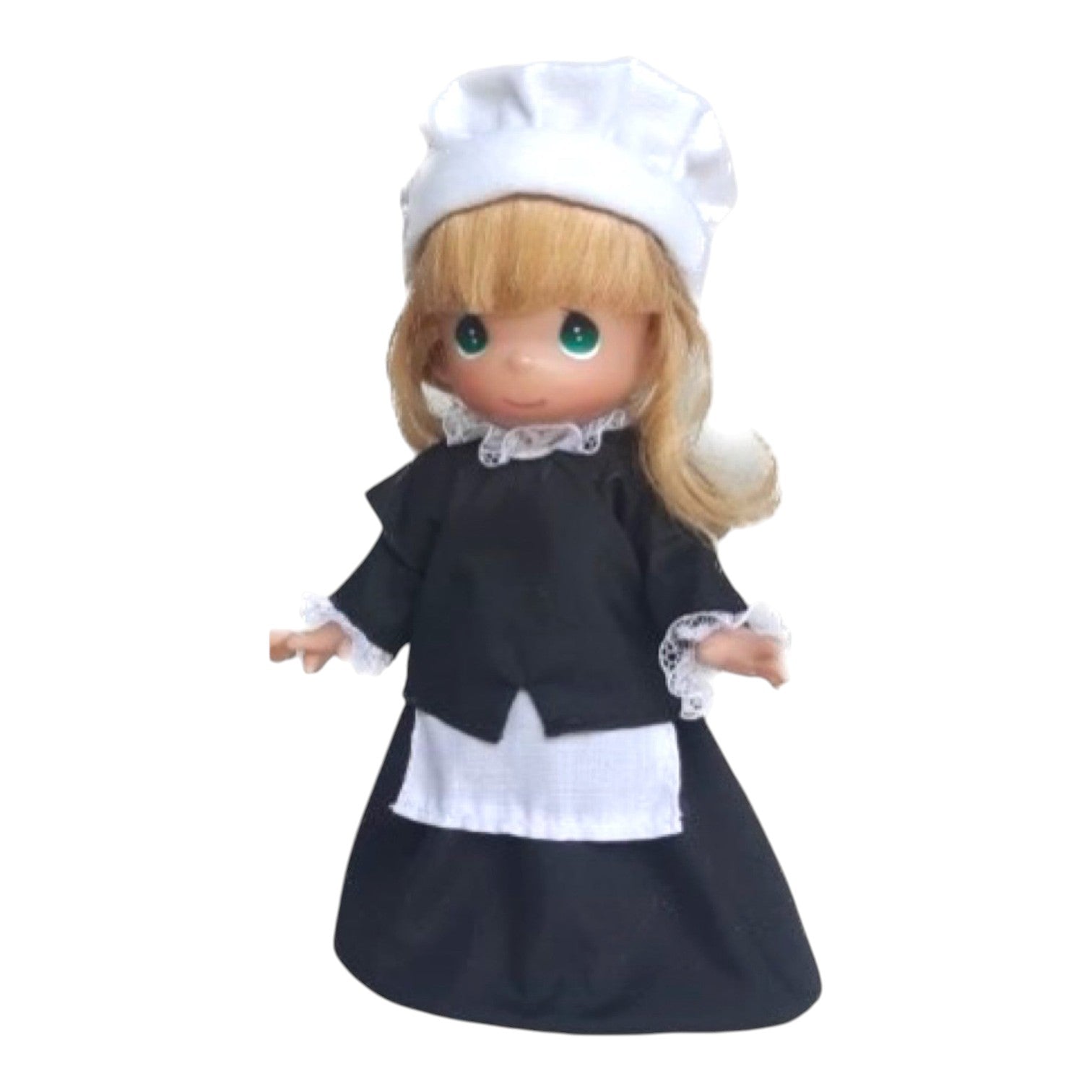 The Doll Maker 9-inch Pilgrim Girl doll with blonde hair, green eyes, and a traditional black and white dress.
