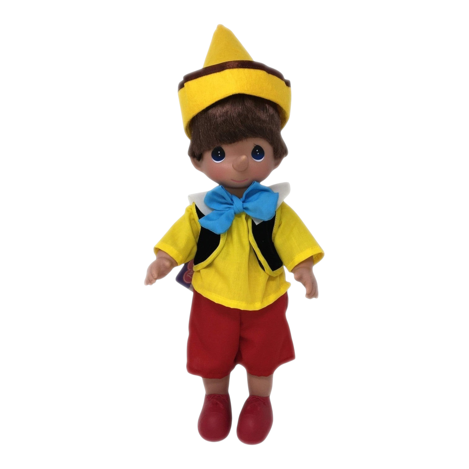 The Doll Maker 12-inch Pinocchio doll wearing a yellow hat, yellow shirt, blue bow tie, and red shorts.