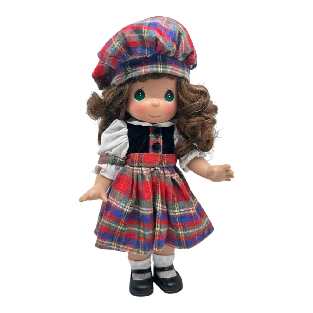 The Doll Maker collectible doll with curly brown hair wearing a red, blue, and green plaid dress, beret, and bodice.