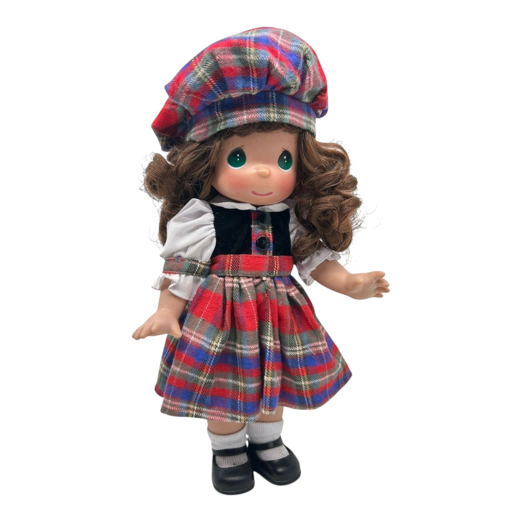 The Doll Maker collectible doll wearing a red, blue, and green plaid dress, matching beret, and black bodice.