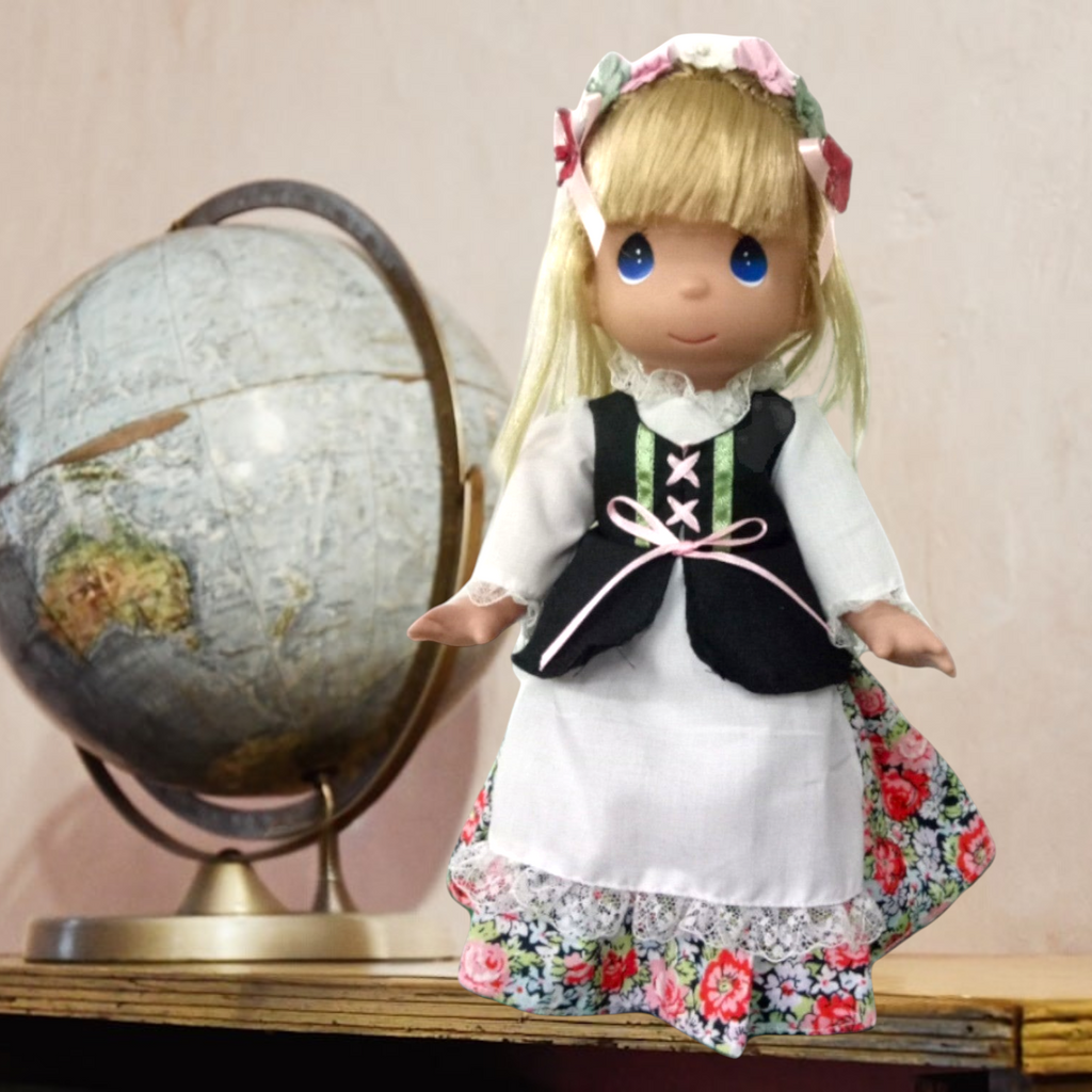 The Doll Maker 12-inch Polish costume doll with blonde hair, floral headpiece, and traditional folk dress.