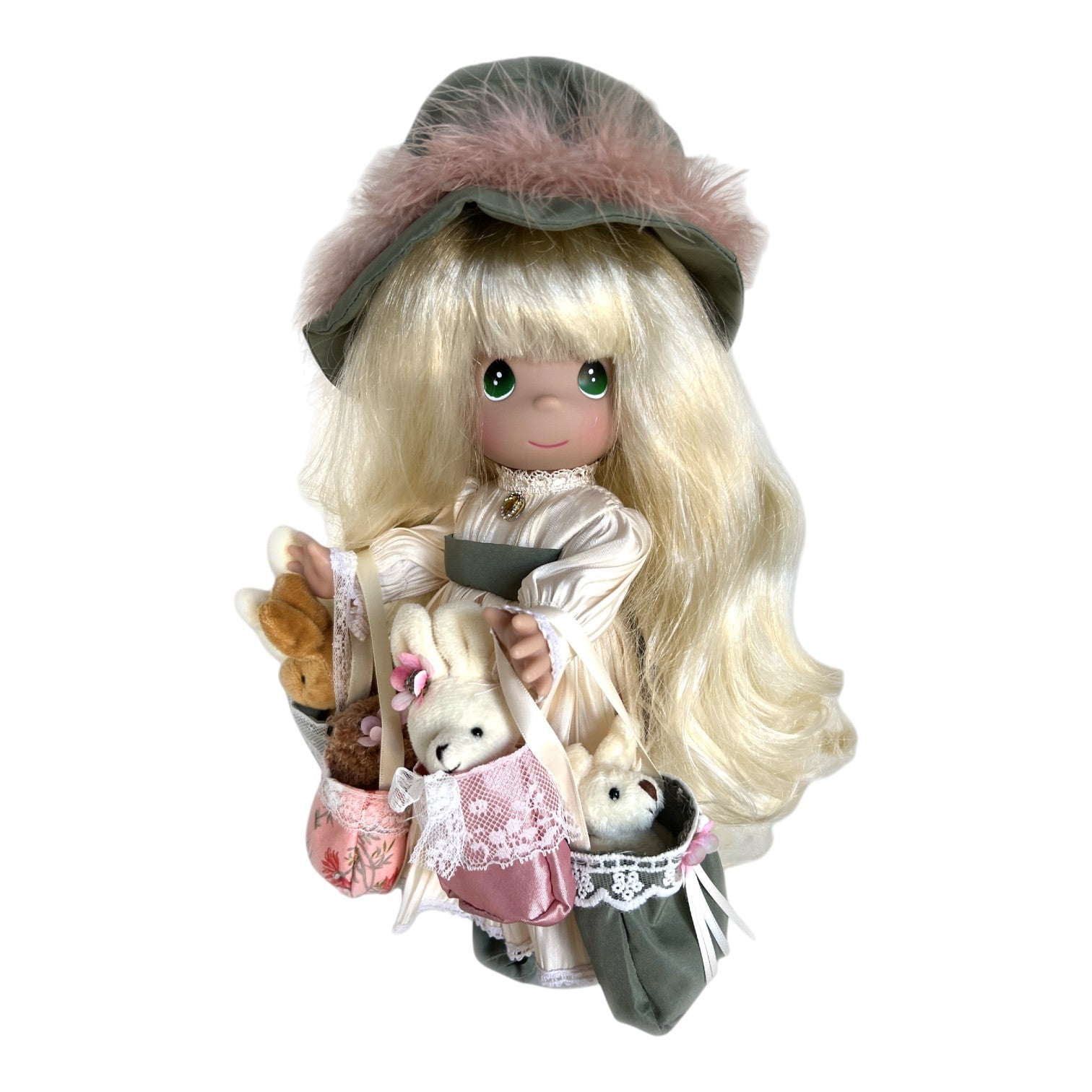 The Doll Maker 12-inch Precious Moments vinyl doll with blonde hair, green hat, and plush animals in shopping bags.