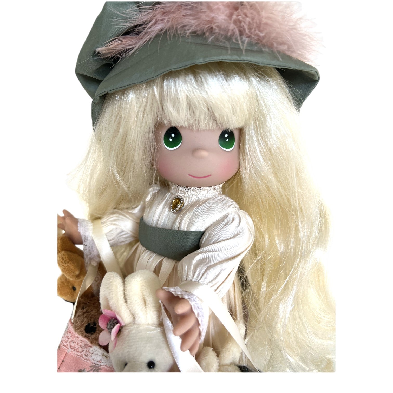 The Doll Maker 12-inch Precious Moments vinyl doll with blonde hair, green hat, and plush animal shopping bags.