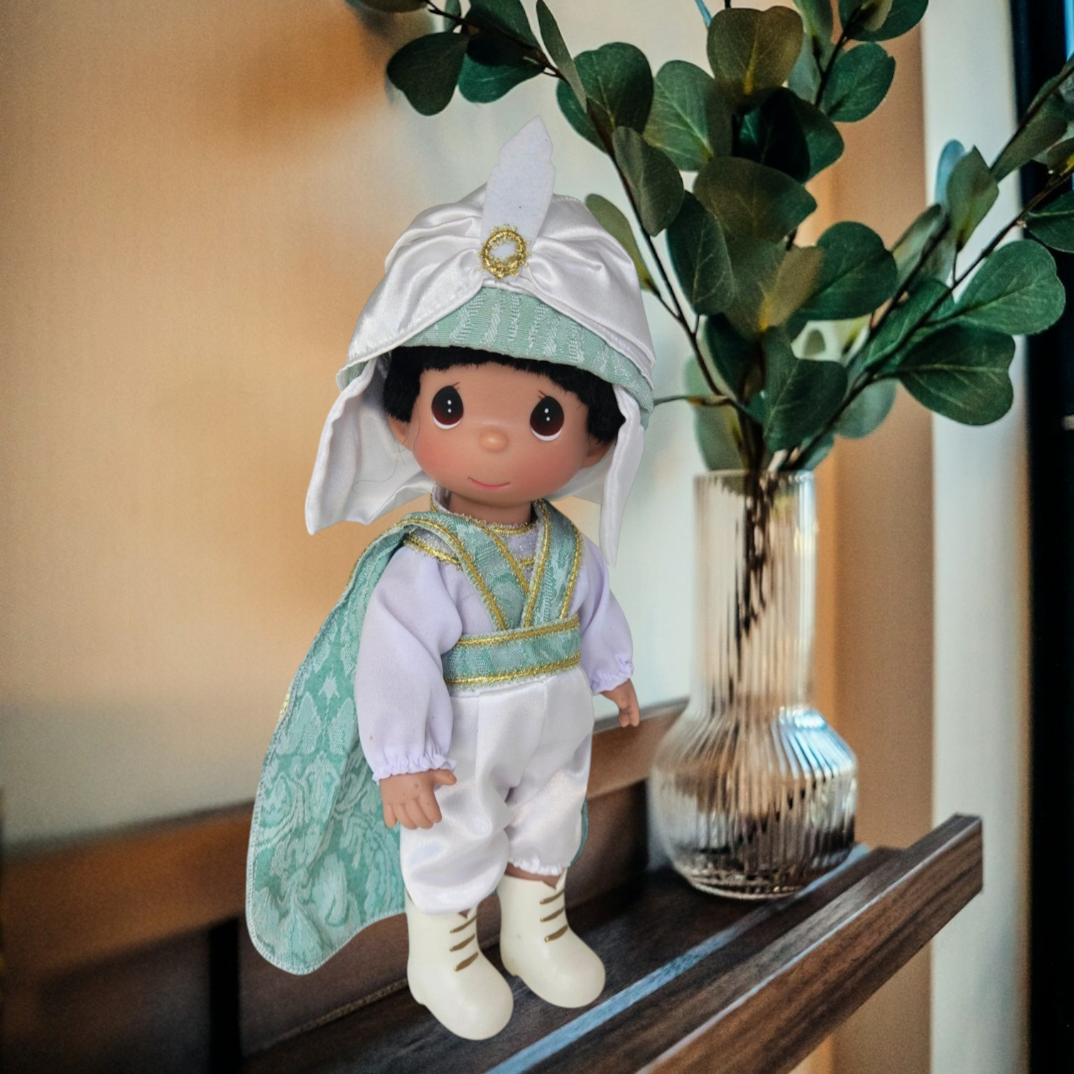 The Doll Maker Prince Ali 12-inch vinyl doll wearing a white and mint green turban, cape, and matching outfit.