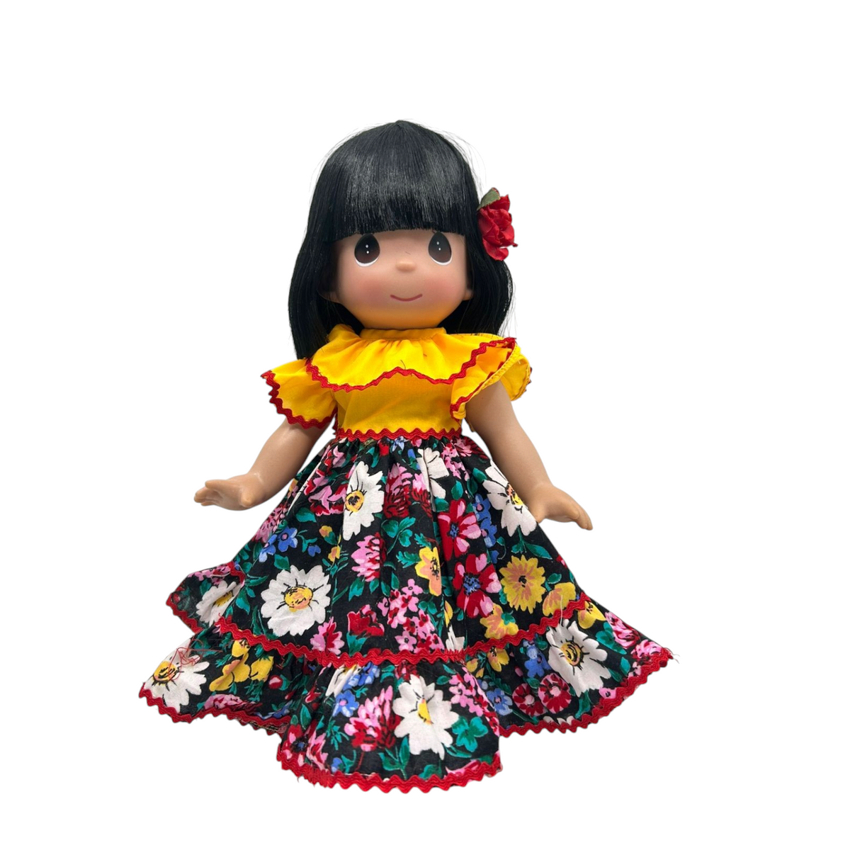 The Doll Maker 12-inch Puerto Rico doll with black hair, yellow top, and floral print skirt with red trim.