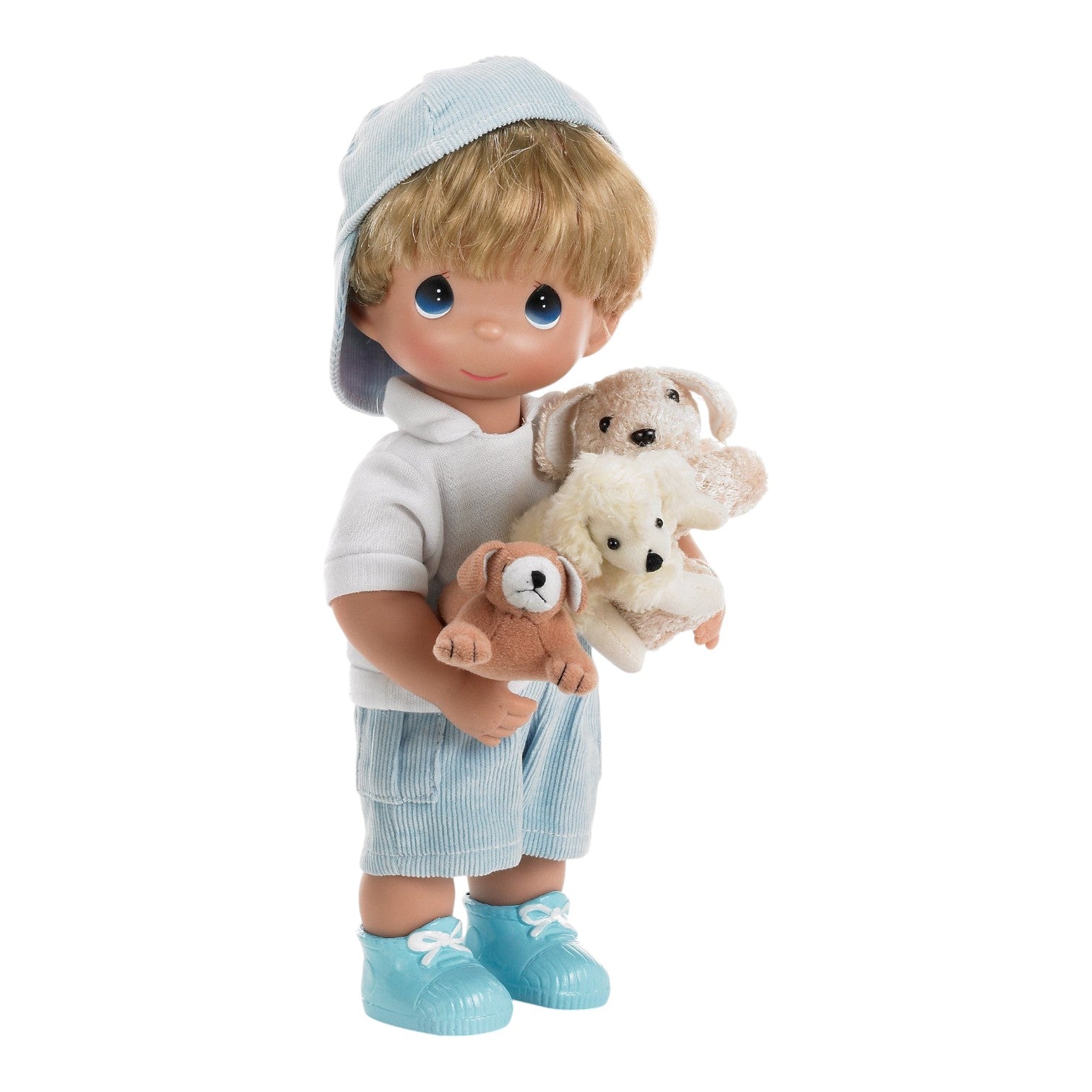 The Doll Maker 12-inch vinyl boy doll wearing a blue cap, white shirt, and blue shorts, holding three plush puppies.