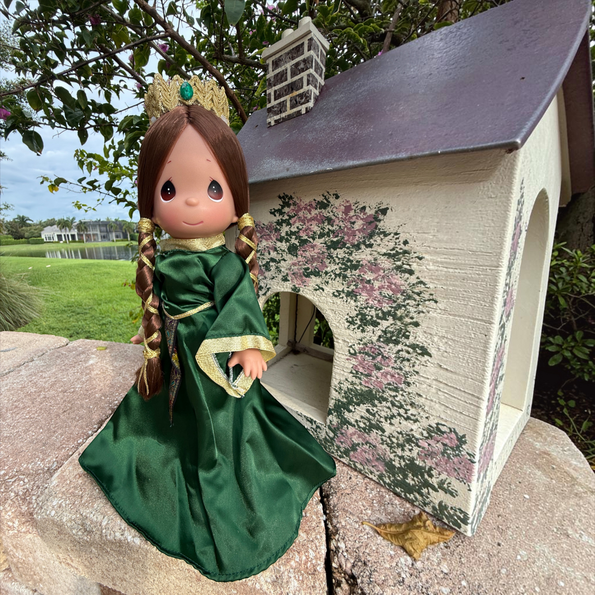 The Doll Maker Queen Elinor 12-inch collectible doll from Brave wearing an emerald green gown with gold trim and crown