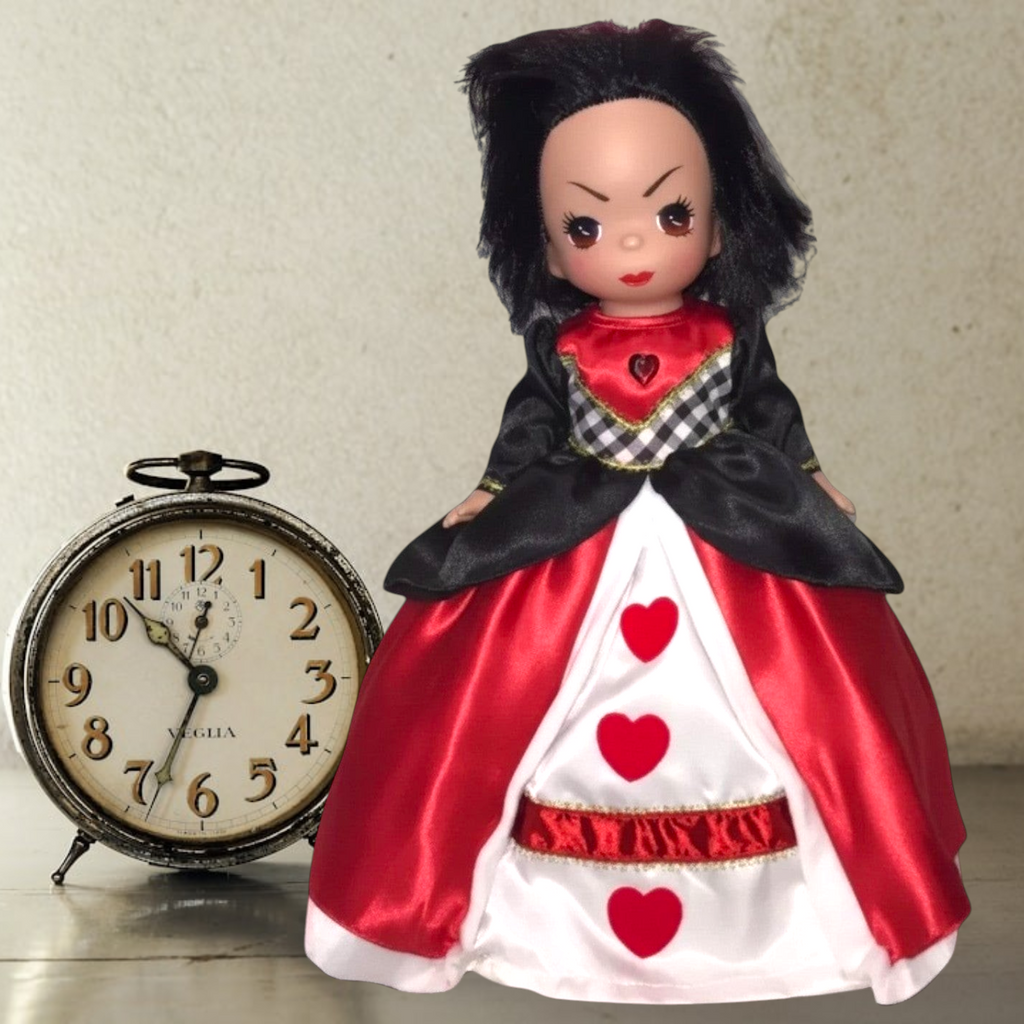 The Doll Maker Queen of Hearts doll with messy black hair wearing a red, white, and black satin gown with heart motifs