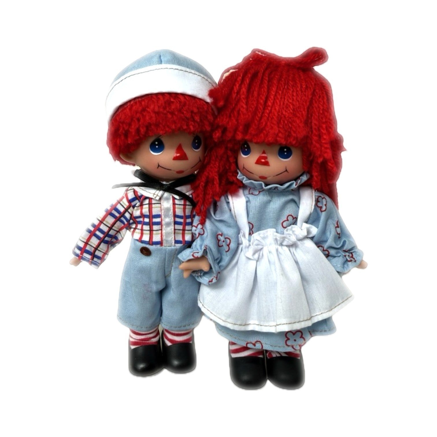 The Doll Maker 7-inch Raggedy Ann and Andy vinyl dolls wearing classic blue and red outfits with yarn hair.
