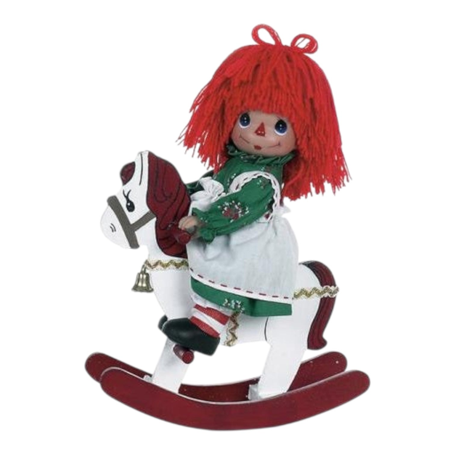 The Doll Maker 9 inch Raggedy Ann Christmas doll with red yarn hair, wearing a green dress on a white rocking horse.