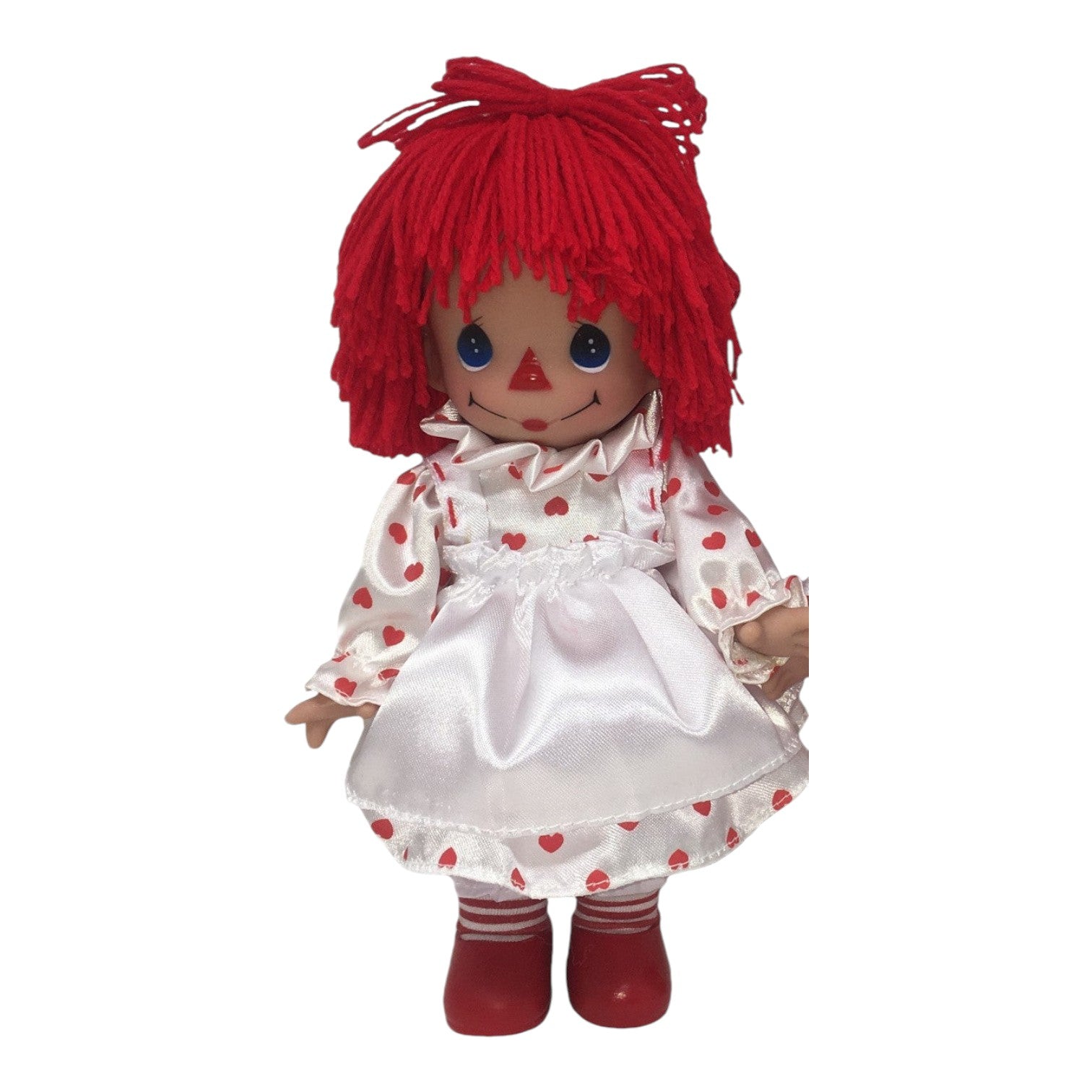 The Doll Maker 9-inch Raggedy Ann Love Being With You vinyl doll wearing a white heart-print dress and red shoes.