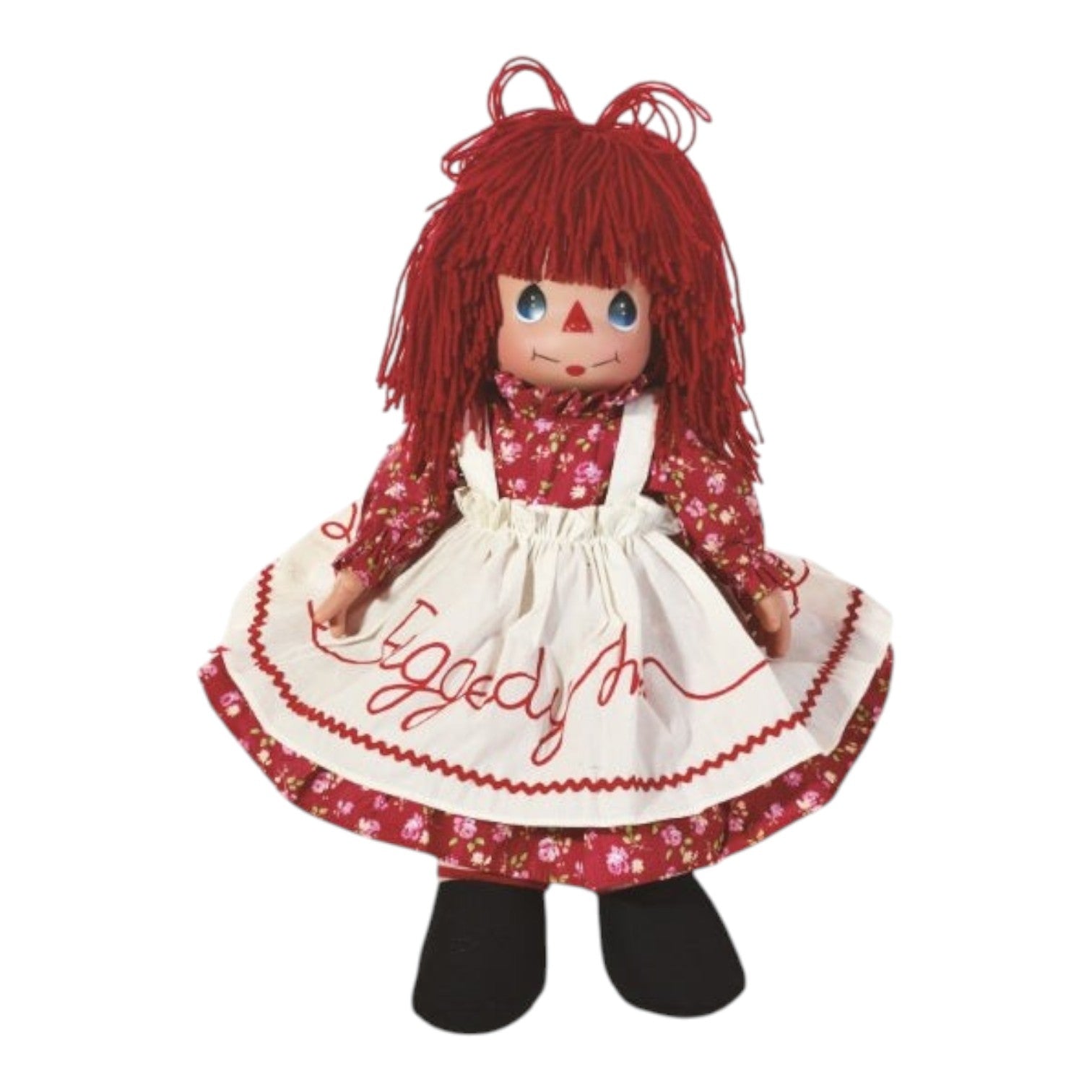 The Doll Maker 16-inch Raggedy Ann vinyl doll with red yarn hair, floral dress, and embroidered white apron.