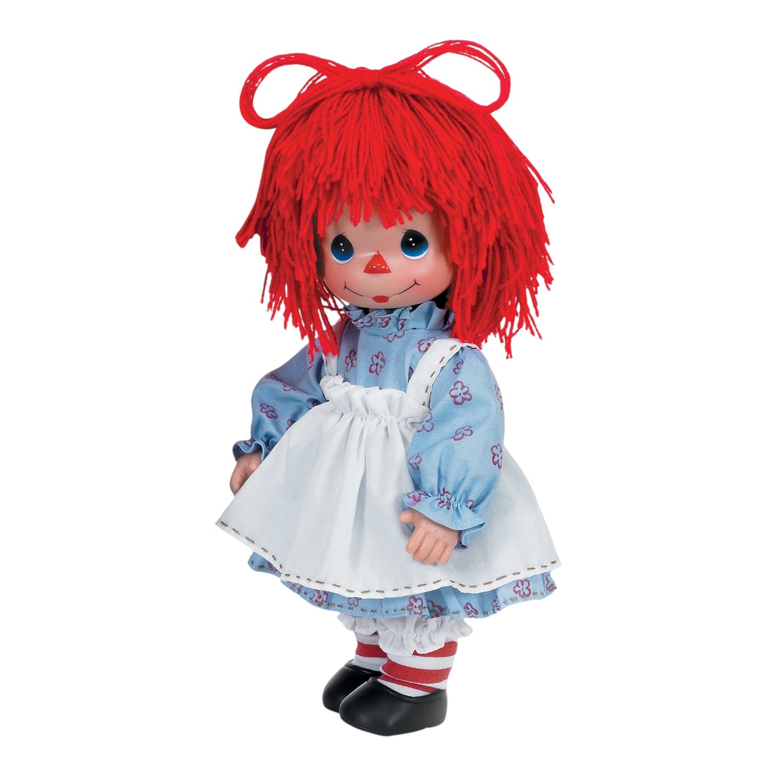 The Doll Maker 12-inch Raggedy Ann vinyl doll with bright red yarn hair, blue floral dress, and white apron.