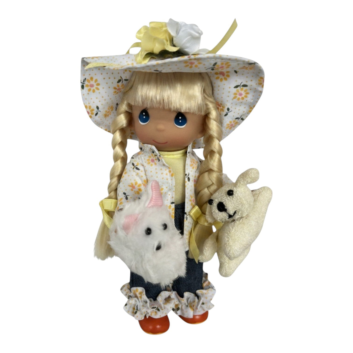 The Doll Maker Raining Cats and Dogs 7-inch vinyl doll wearing a floral rain hat, coat, and rubber ducky boots.