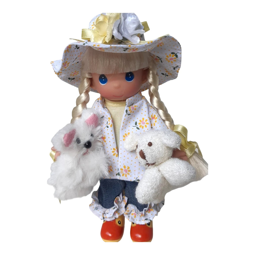 The Doll Maker Raining Cats and Dogs 7-inch vinyl doll wearing a floral raincoat, hat, and rubber ducky boots.