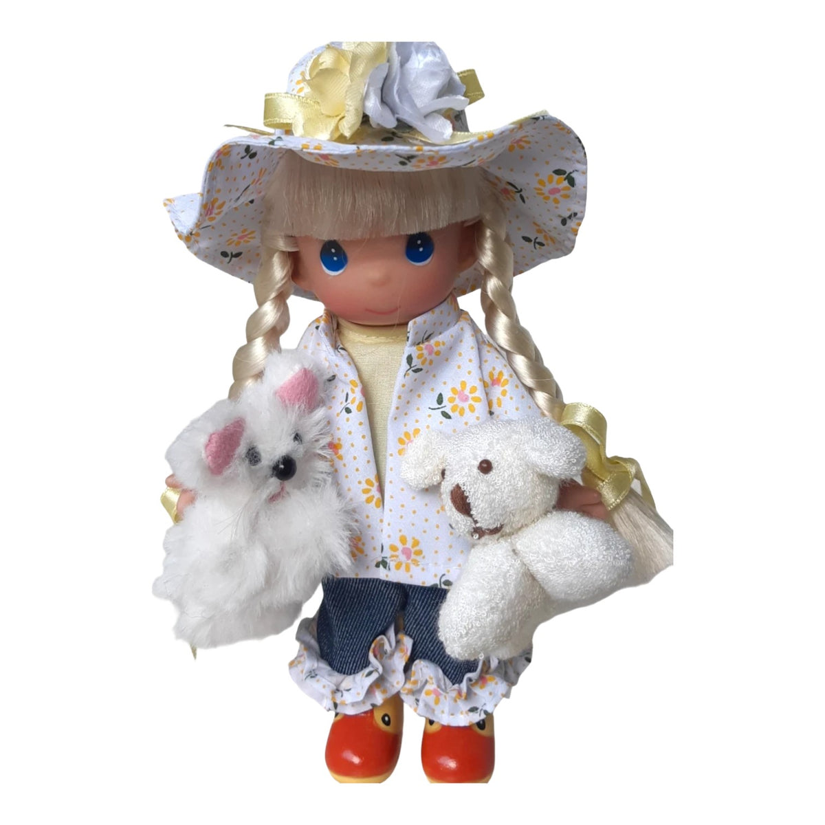The Doll Maker Raining Cats and Dogs 7-inch vinyl doll wearing a floral raincoat, hat, and rubber ducky boots.