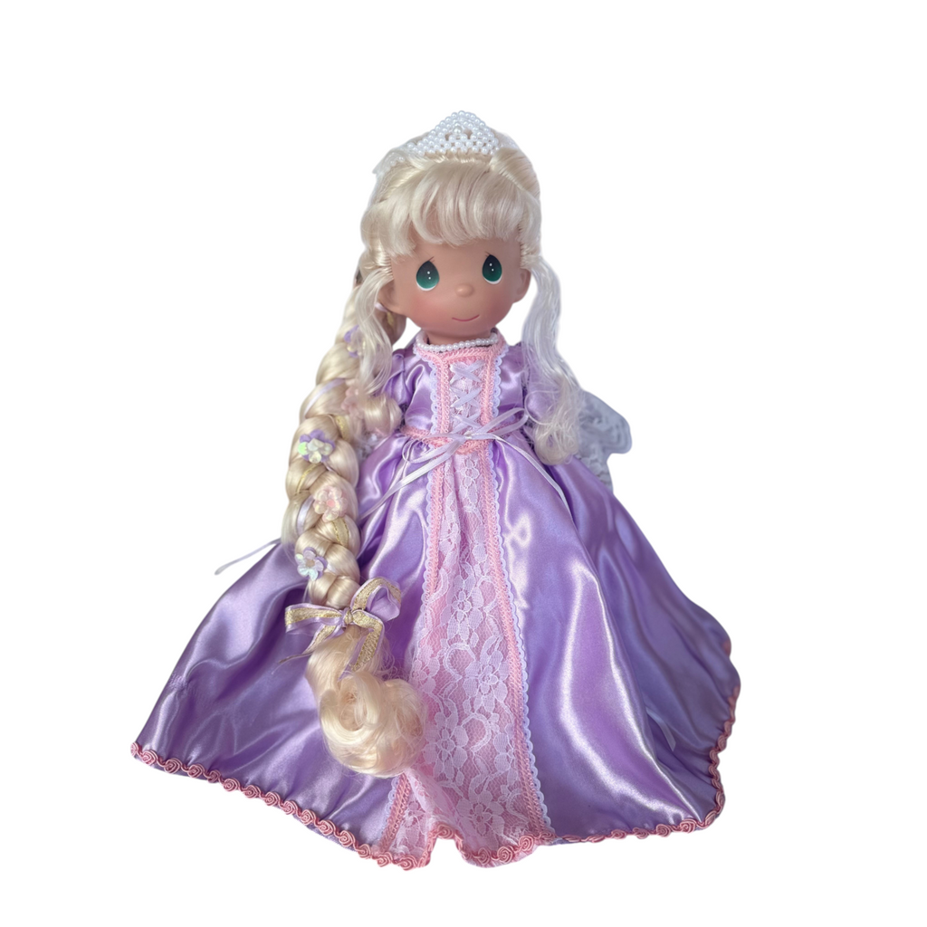 The Doll Maker 12-inch Rapunzel doll with long blonde braided hair wearing a purple satin gown with lace trim