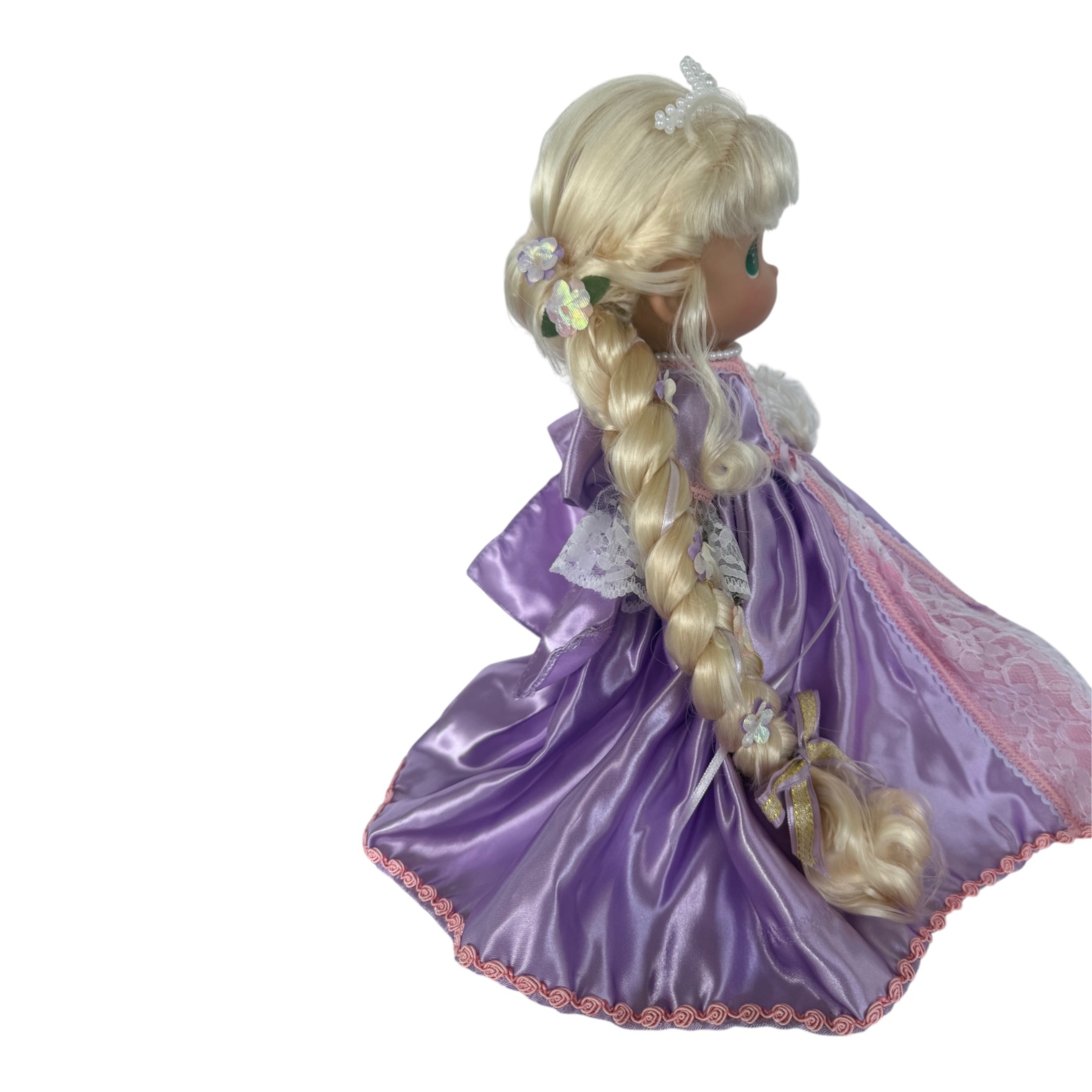 The Doll Maker 12-inch Rapunzel doll with long blonde braided hair wearing a purple satin gown with lace trim