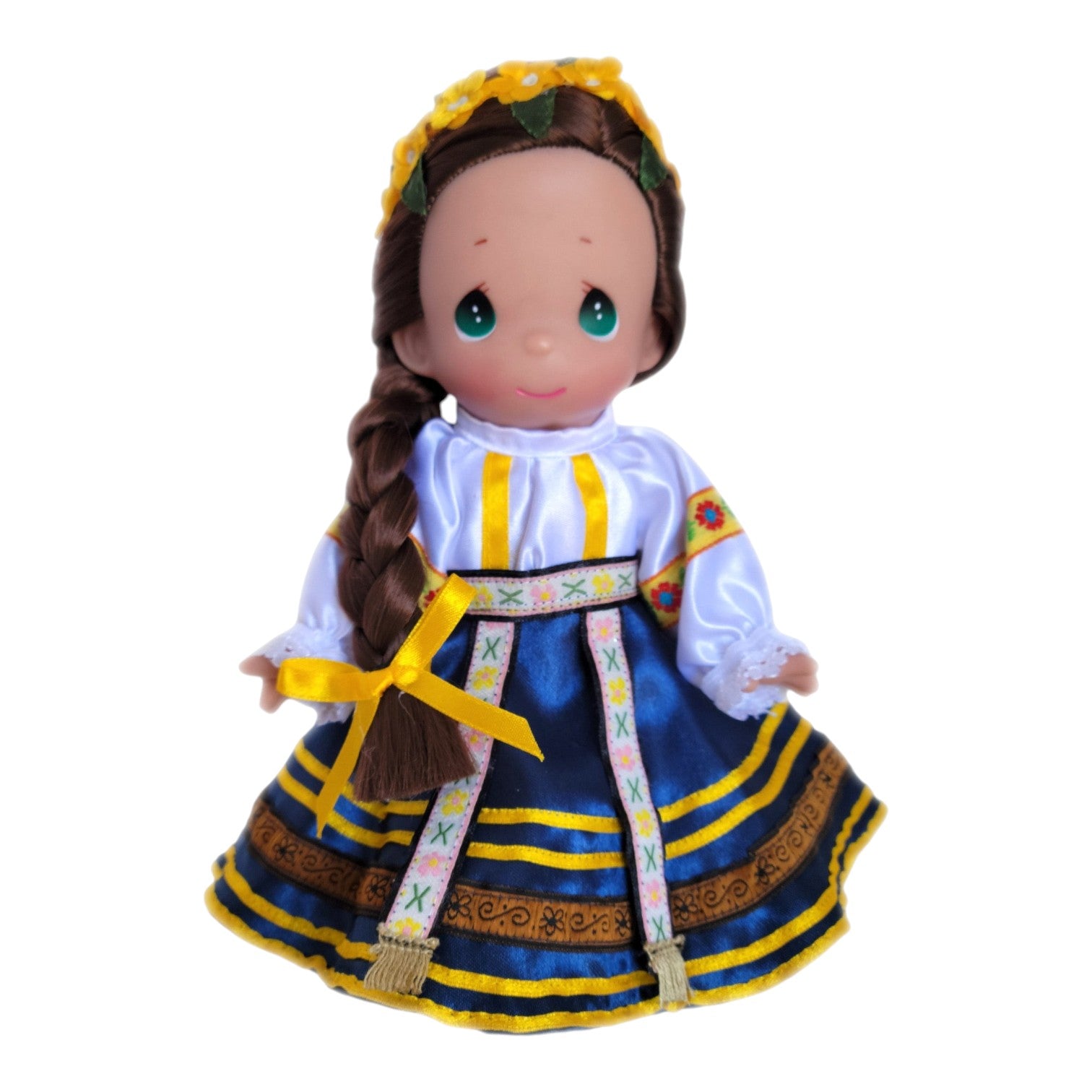 The Doll Maker 9-inch Romania Petronella vinyl doll wearing a traditional blue and yellow folk costume with a braid.