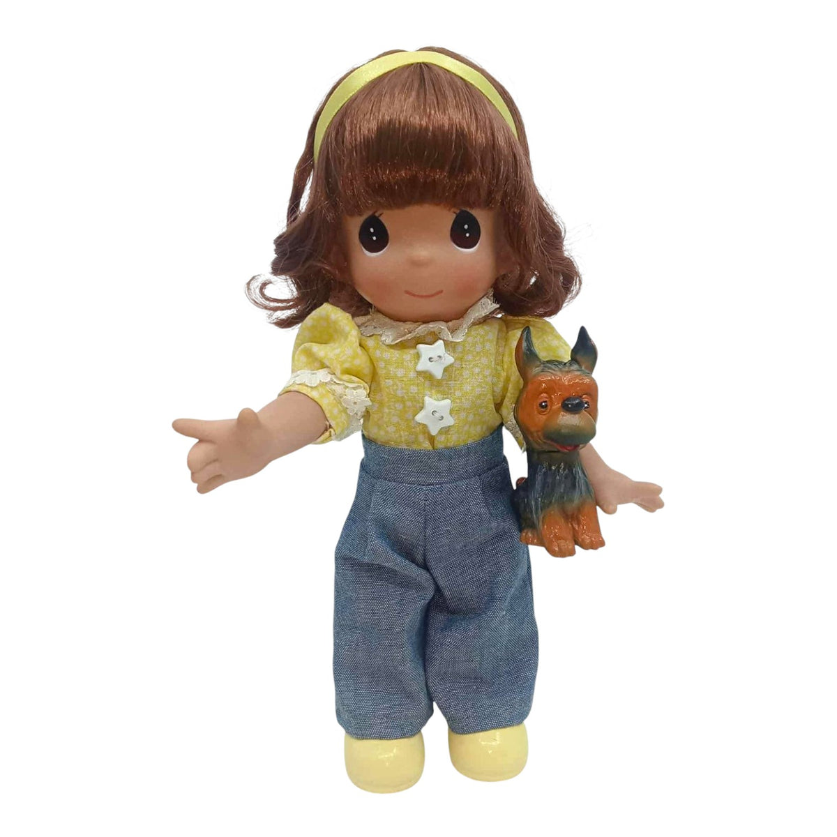 The Doll Maker 9-inch Rosemarie collector doll wearing a yellow floral blouse and blue pants with a small toy dog