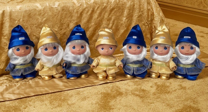 The Doll Maker 50th anniversary Seven Dwarfs doll set in blue and gold outfits with hand-finished details.