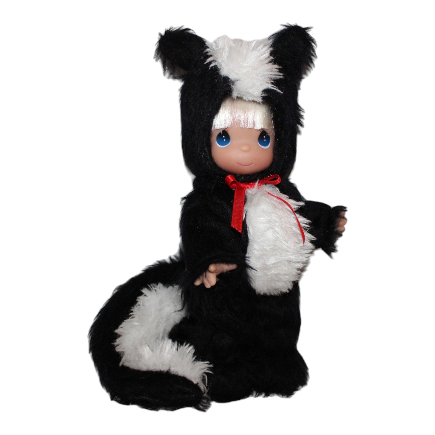 The Doll Maker 9-inch skunk doll with white hair, blue eyes, and a black and white plush skunk costume with a red bow.