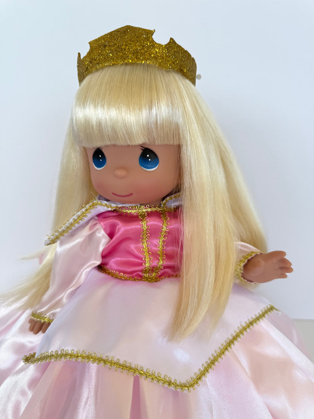 The Doll Maker 12-inch Sleeping Beauty doll with blonde hair, blue eyes, gold glitter crown, and pink satin dress.