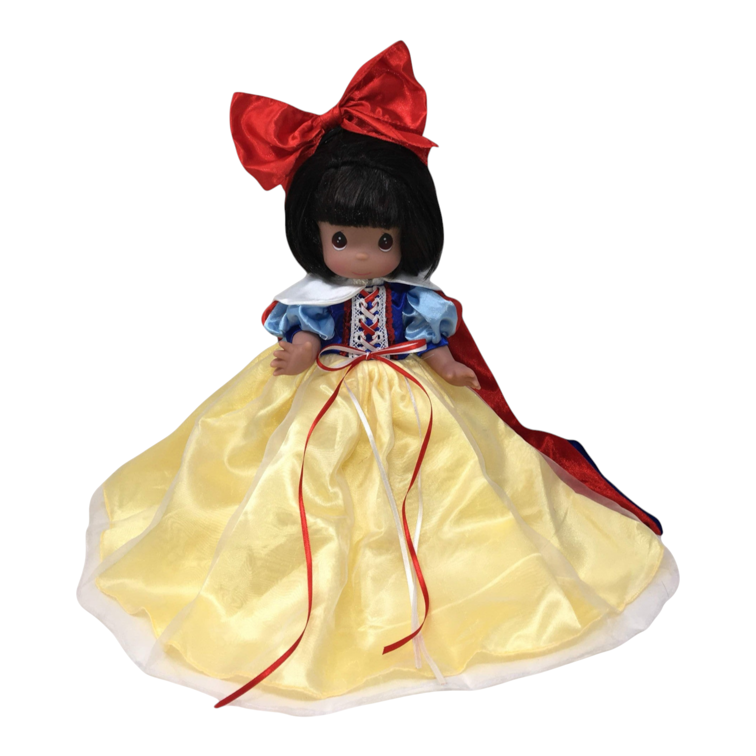 The Doll Maker 12-inch Snow White collectible doll wearing a yellow satin gown, blue bodice, and large red hair bow.