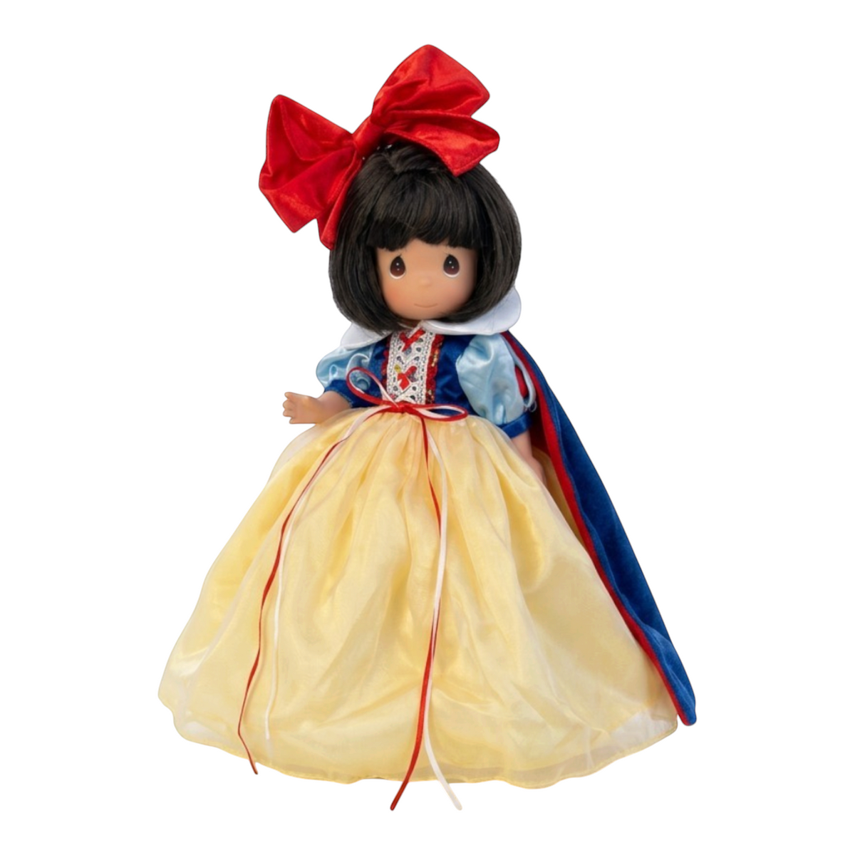 The Doll Maker 12-inch Snow White collectible doll wearing a yellow gown, blue bodice, and a large red hair bow.