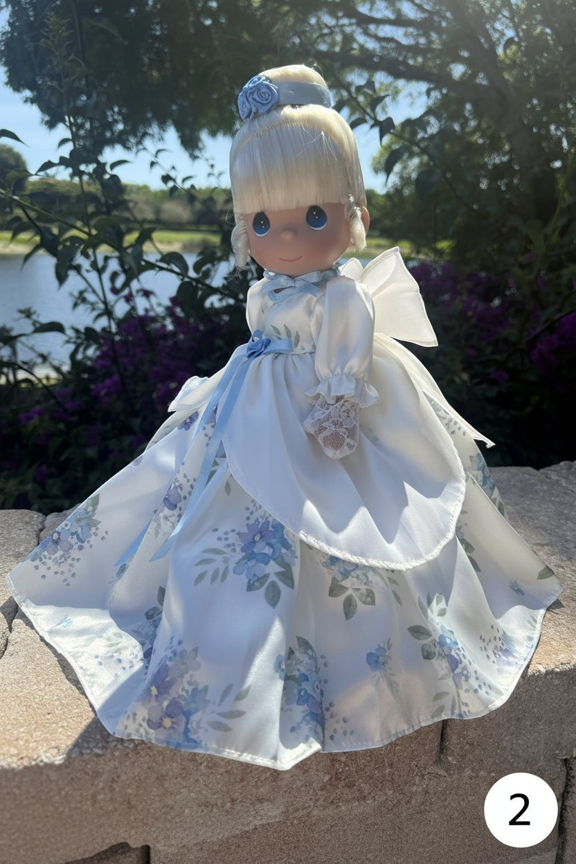The Doll Maker 12 inch Spring Mother's Day princess doll in a white satin gown with blue floral print and lace trim.