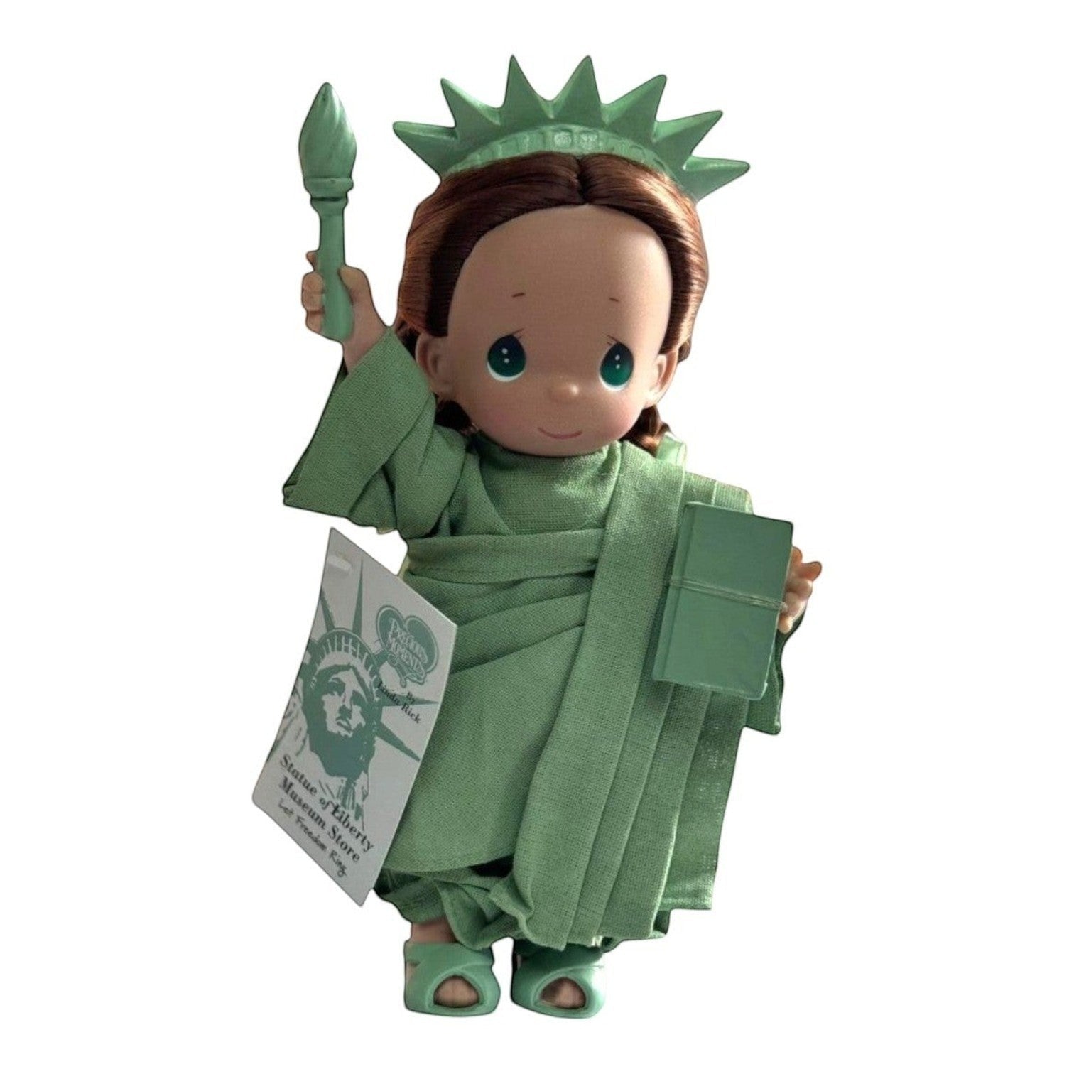 The Doll Maker 9-inch Statue of Liberty vinyl doll with brunette hair, green crown, torch, and tablet.