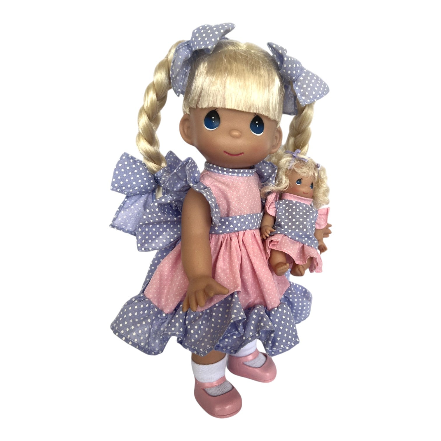 The Doll Maker Summertime Friends 12-inch blonde vinyl doll wearing a pink and blue polka dot dress with a mini doll.