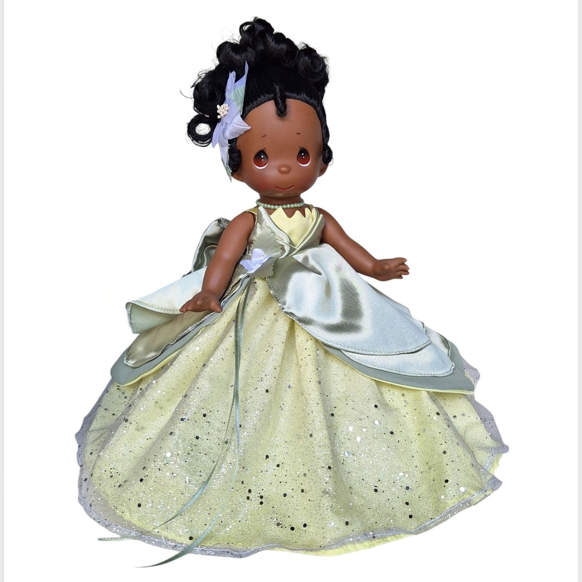 Precious Moments dolls The Doll Maker 12-inch Tiana collectible doll wearing a sparkling green gown with a floral hair accessory.