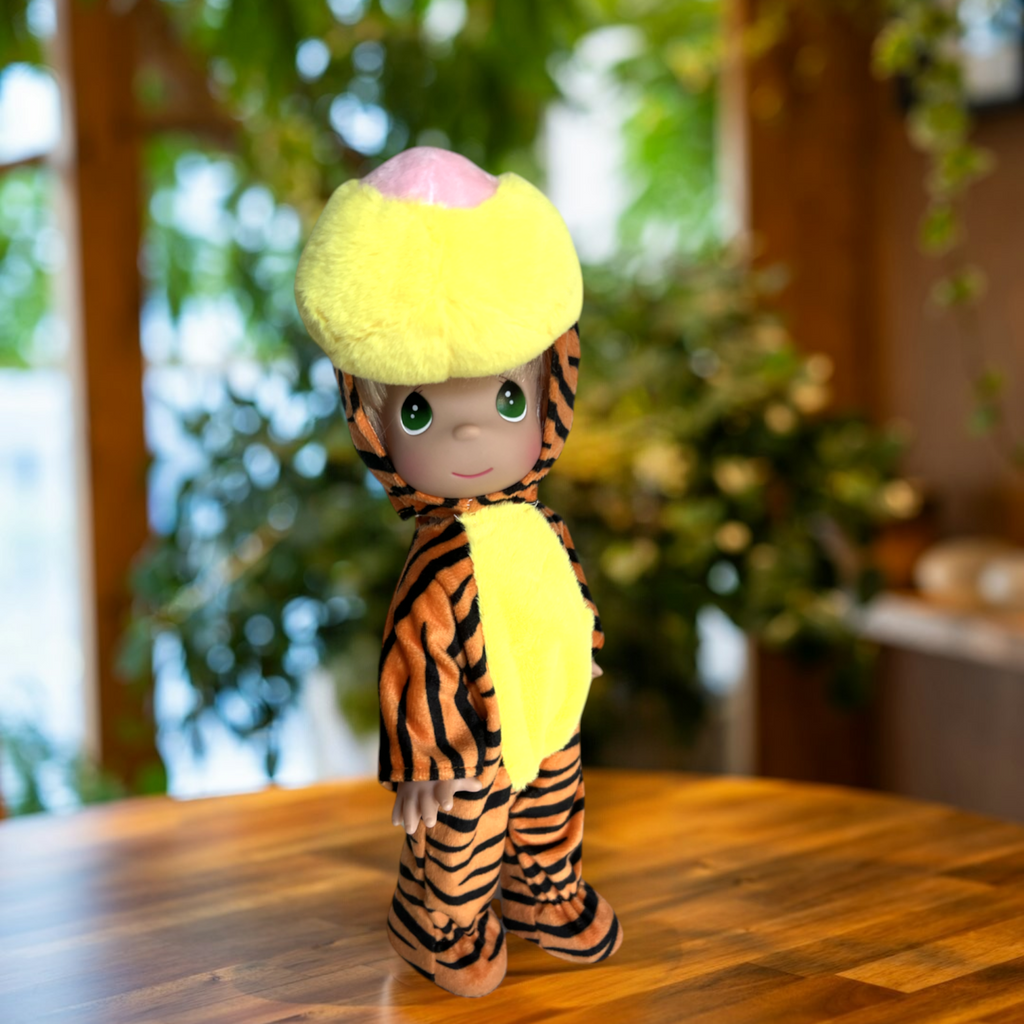 The Doll Maker 12-inch Tigger doll wearing a plush orange and black striped tiger costume with a yellow hood.