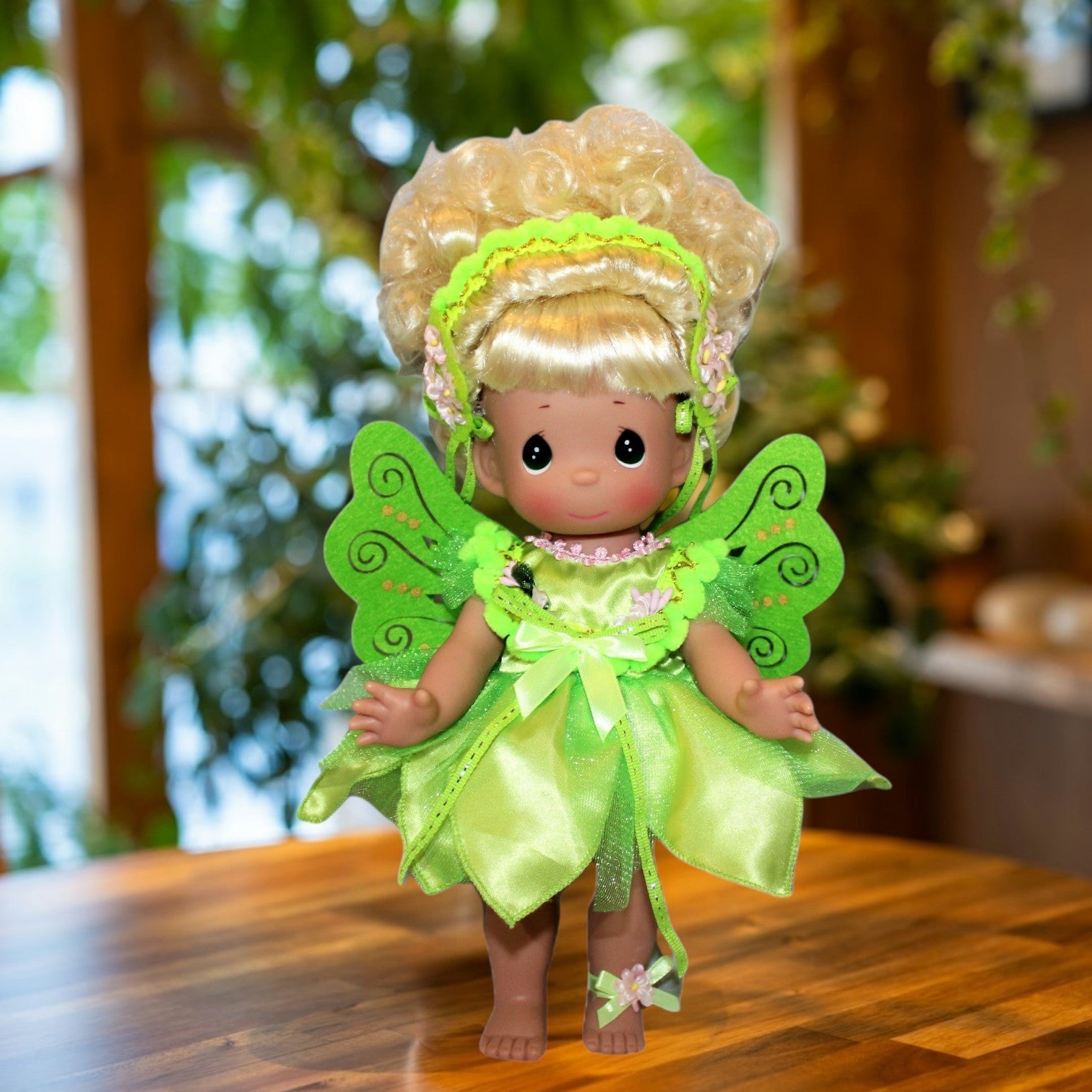 The Doll Maker 12-inch Tinker Bell collectible doll wearing a sparkling green fairy dress and delicate wings.
