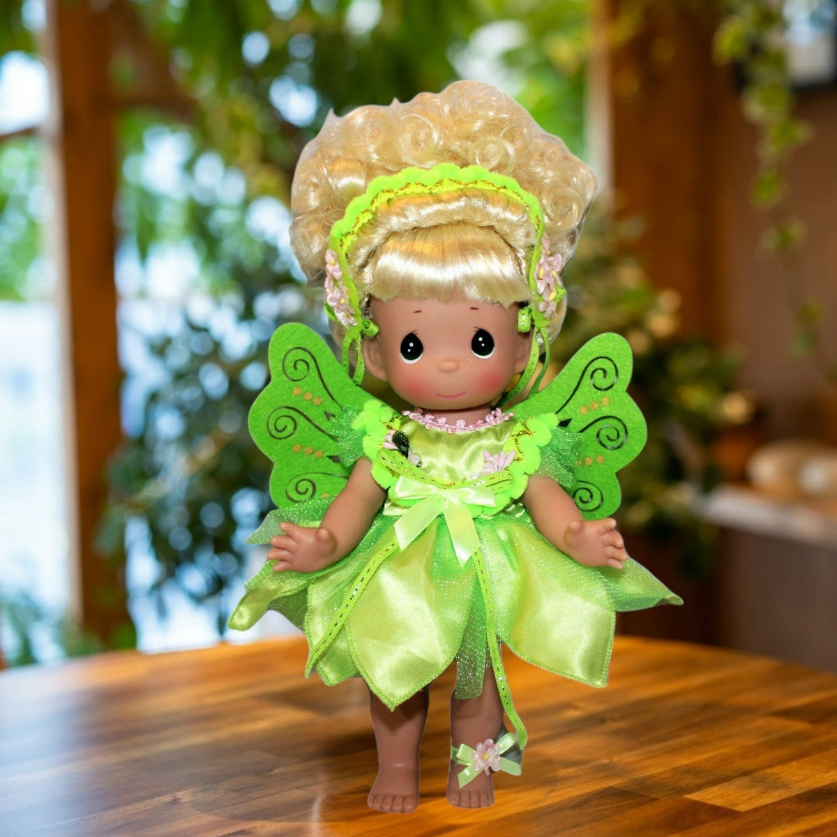 The Doll Maker 12-inch Tinker Bell collectible doll wearing a sparkling green fairy dress and delicate wings.