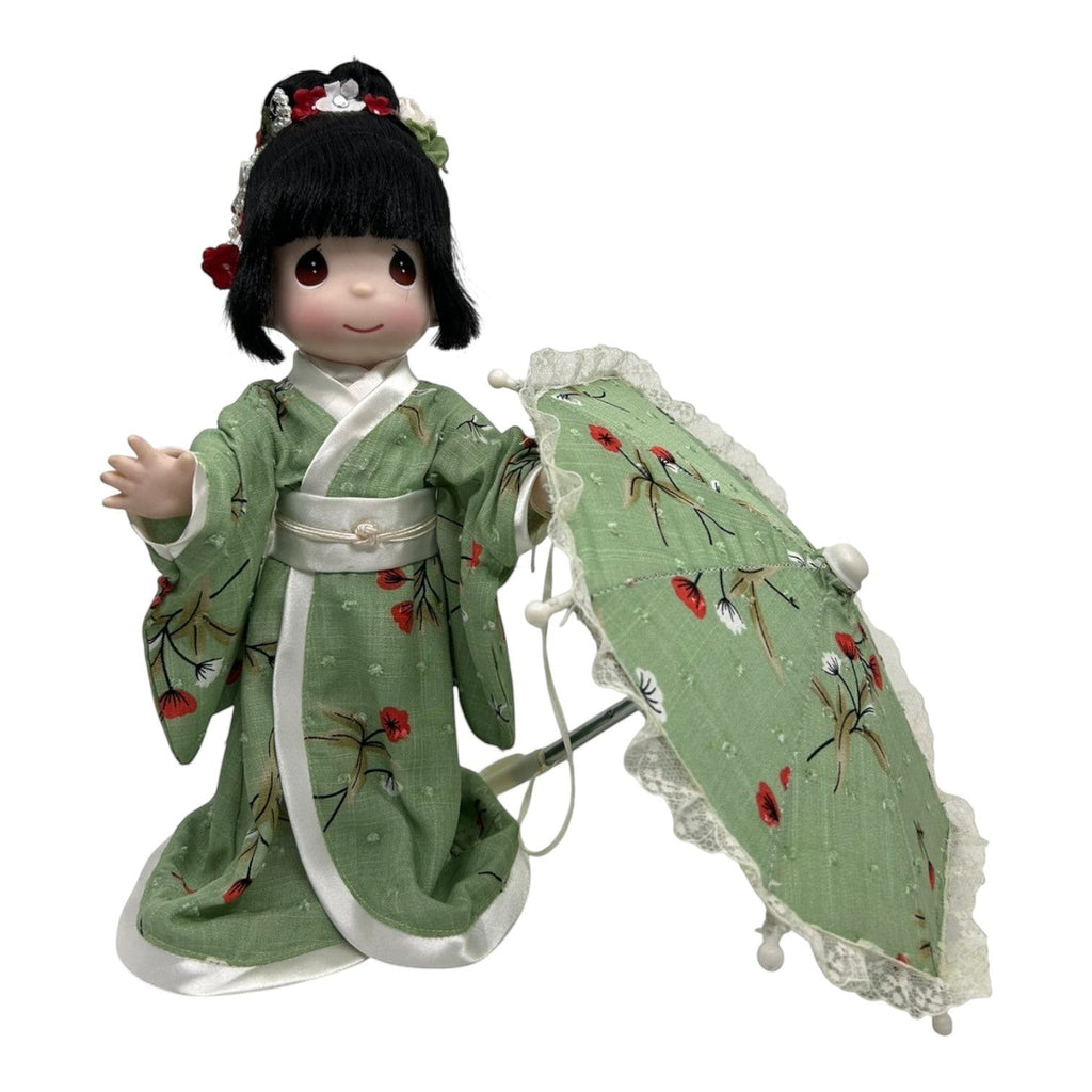 The Doll Maker 12-inch Tomomi doll in a green floral kimono holding a matching parasol with traditional hair styling.