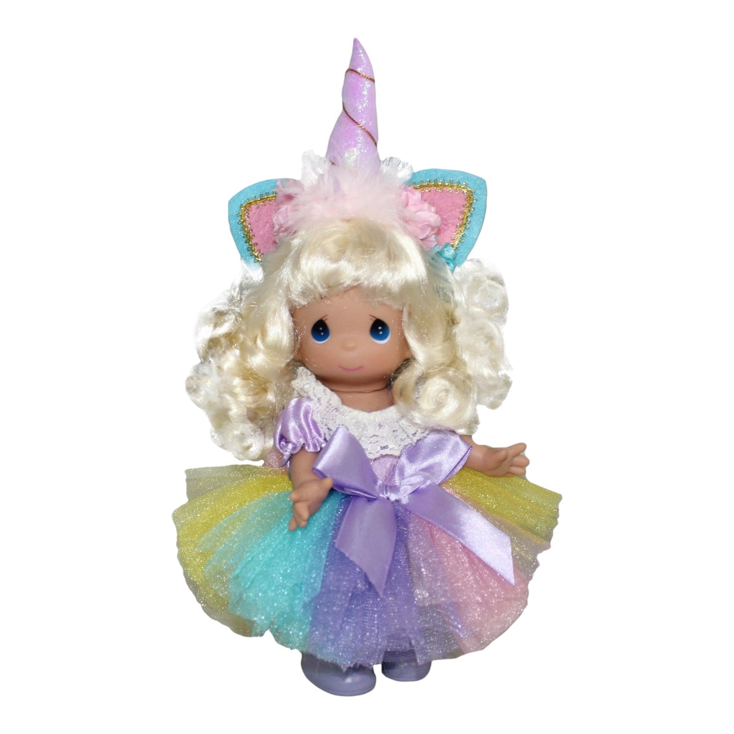 The Doll Maker 9-inch blonde vinyl doll wearing a unicorn horn headband and a colorful pastel rainbow tulle dress.
