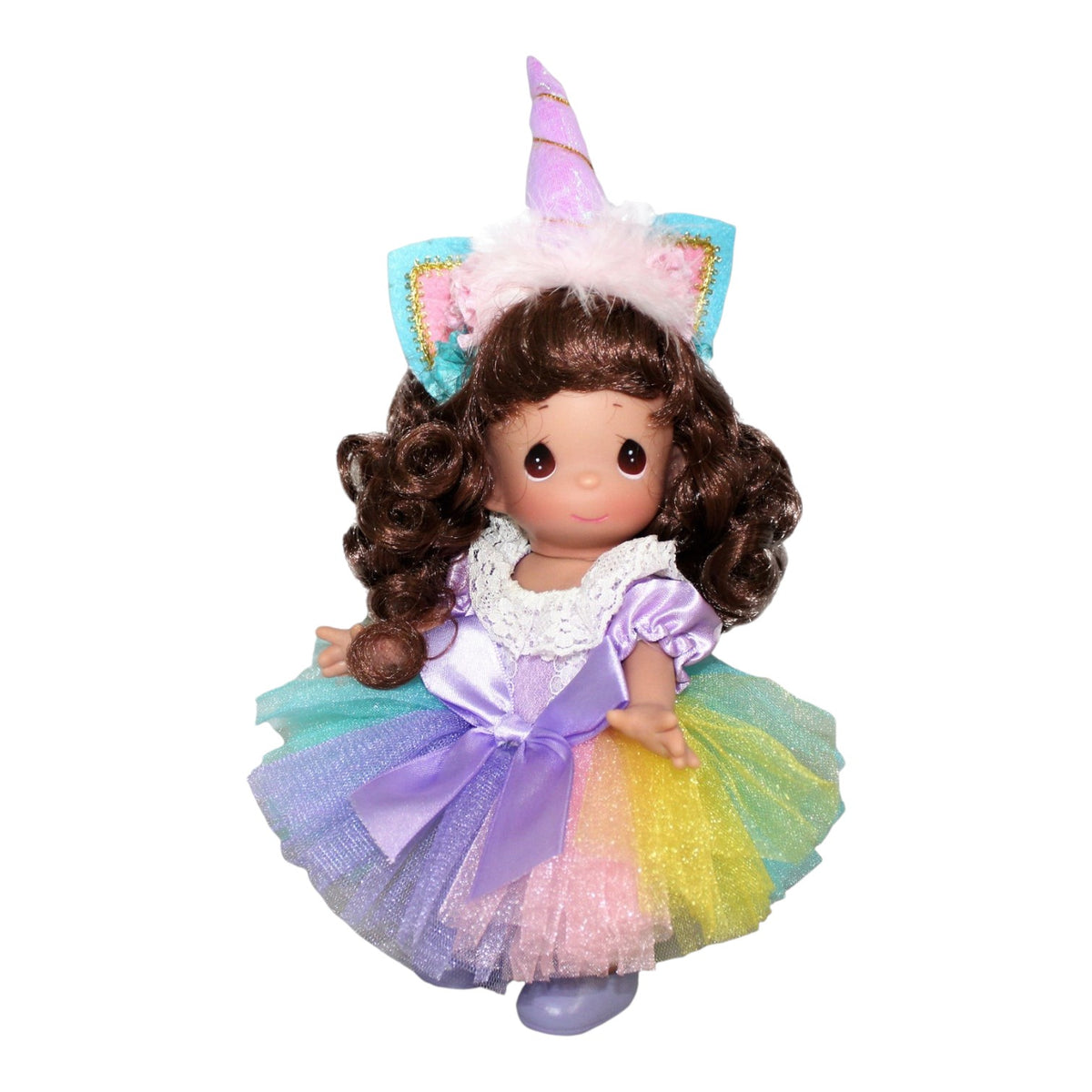 The Doll Maker 9-inch brunette vinyl doll wearing a unicorn horn headband and a pastel rainbow tulle dress.