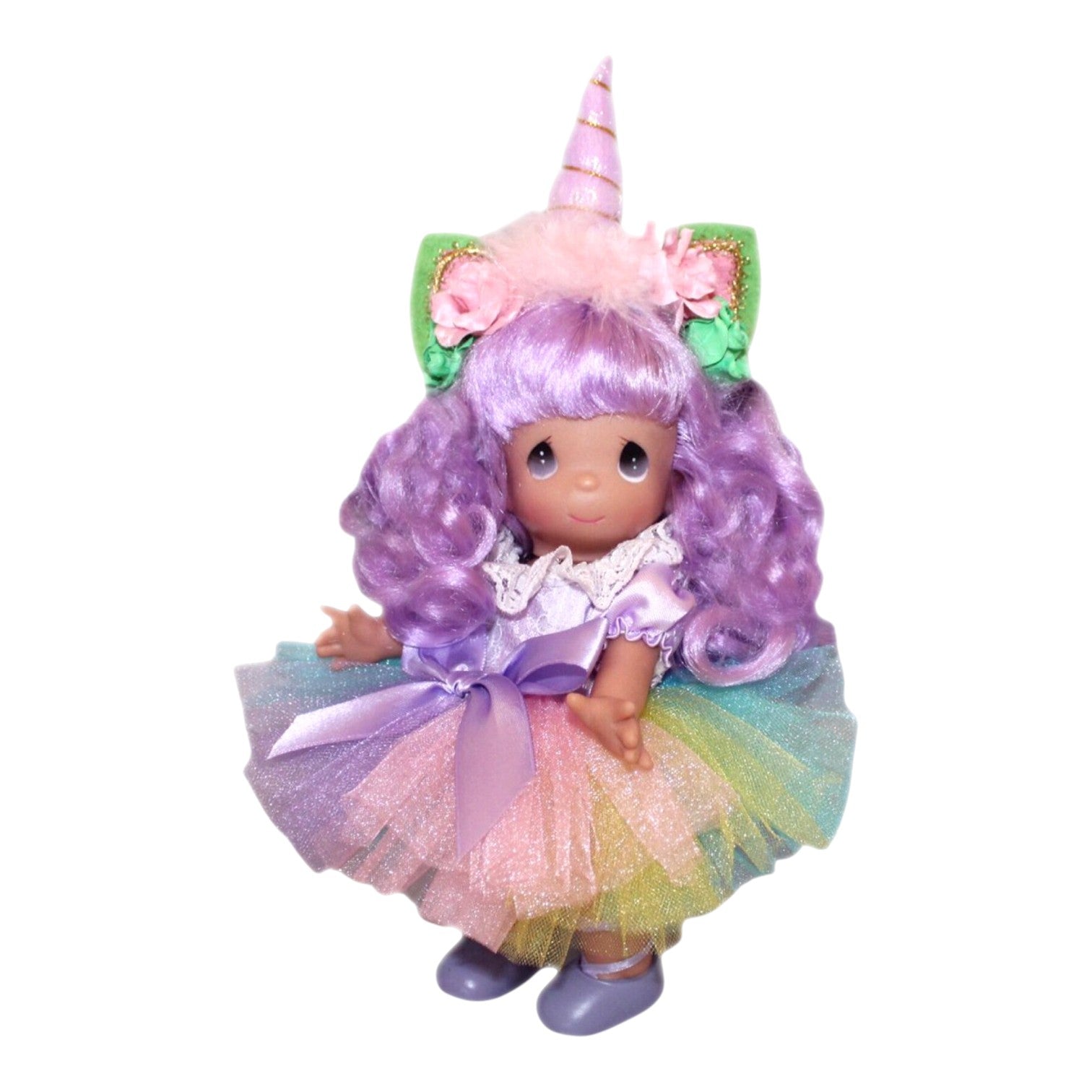 The Doll Maker 9-inch vinyl unicorn doll with purple hair, a unicorn horn headband, and a colorful rainbow tutu dress.