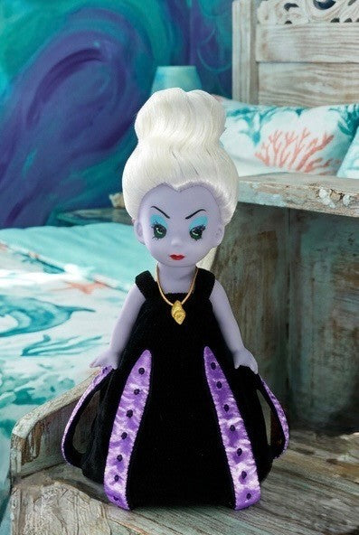 The Doll Maker 12-inch Ursula vinyl doll with white hair, purple skin, and a black dress with purple accents.