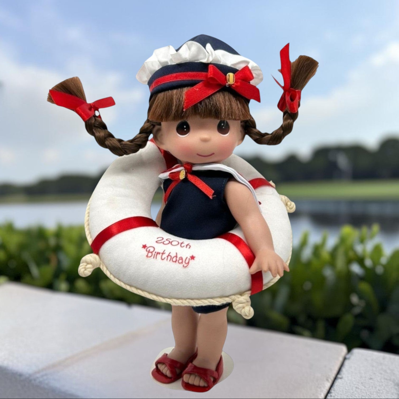 The Doll Maker 12-inch brunette doll in a sailor outfit with a life saver celebrating the USA 250th birthday