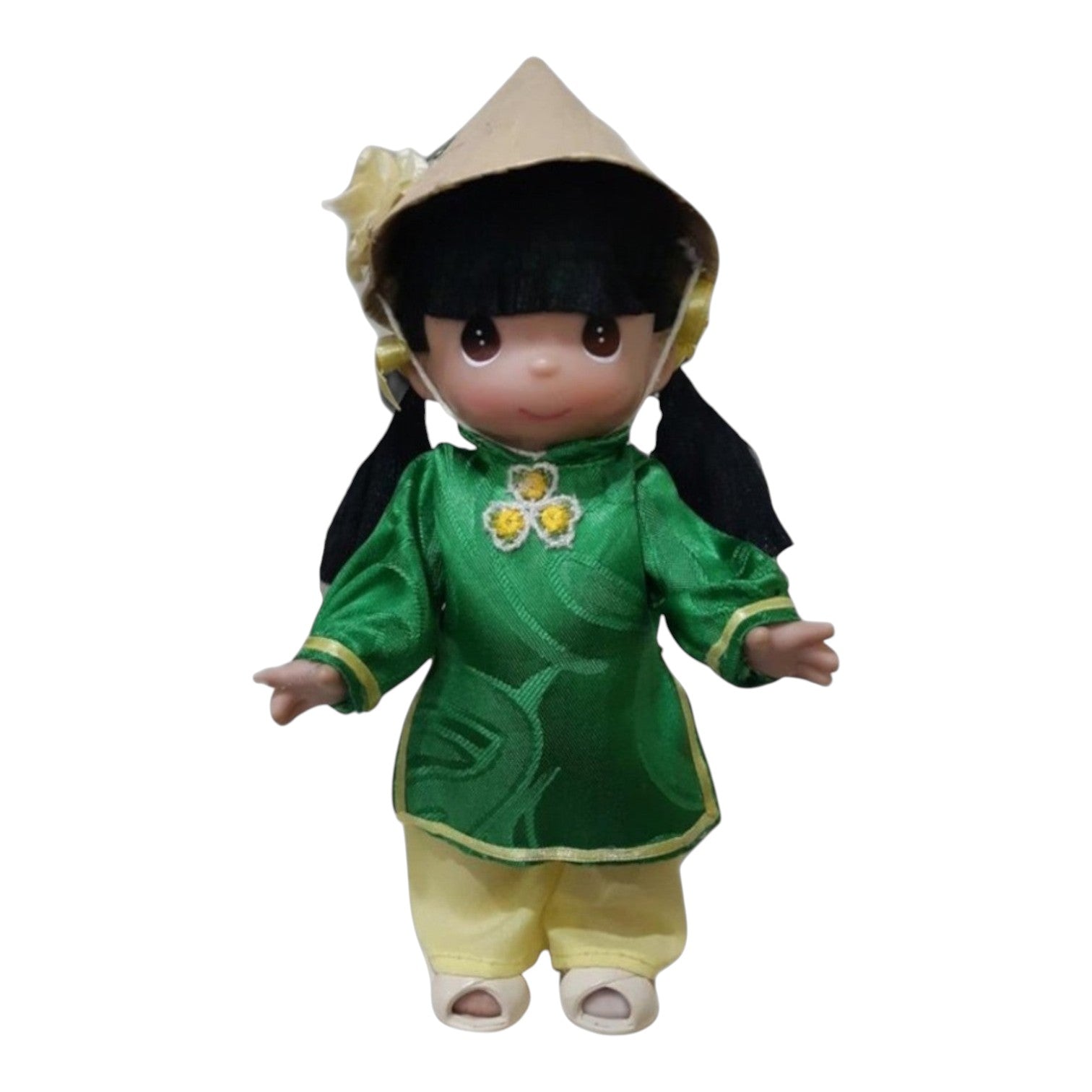 The Doll Maker 9-inch Tam doll from Vietnam wearing a green traditional ao dai with yellow pants and a conical hat.