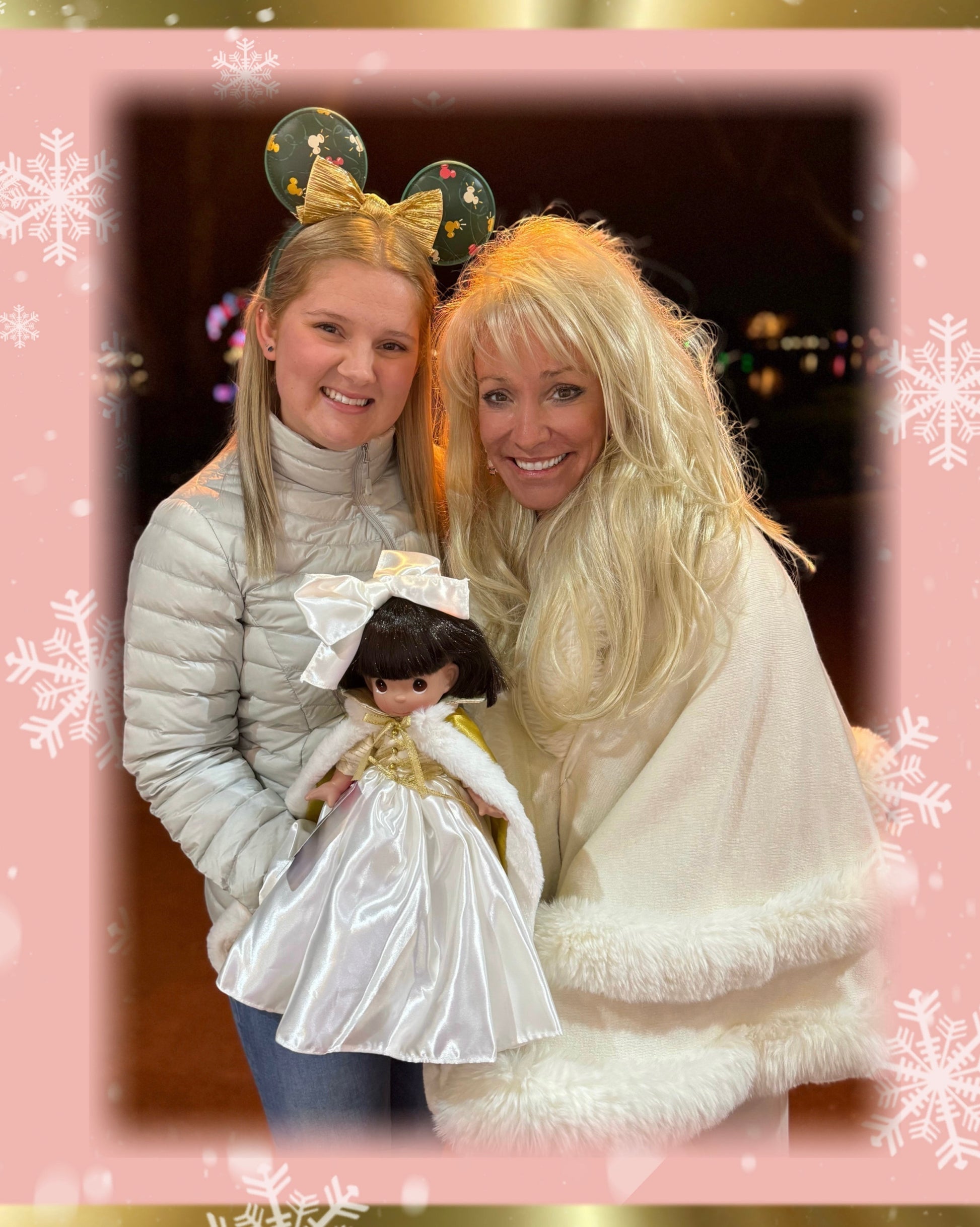 White hooded winter cape with plush fur trim worn by Linda Rick next to a girl holding Snow White doll in a Linda created