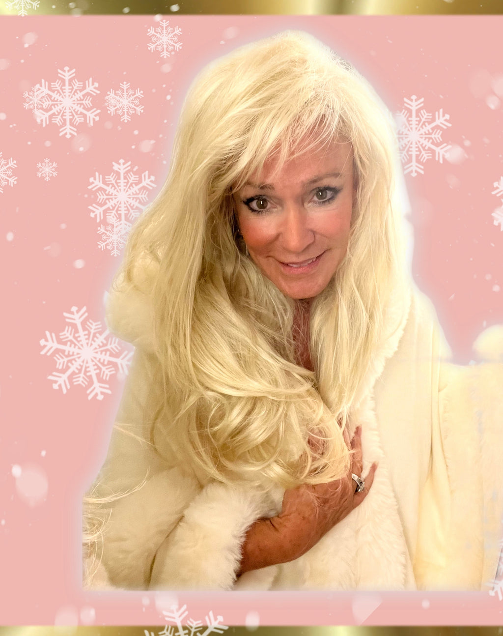White hooded winter cape with plush fur trim worn by Linda Rick against a pink snowflake background