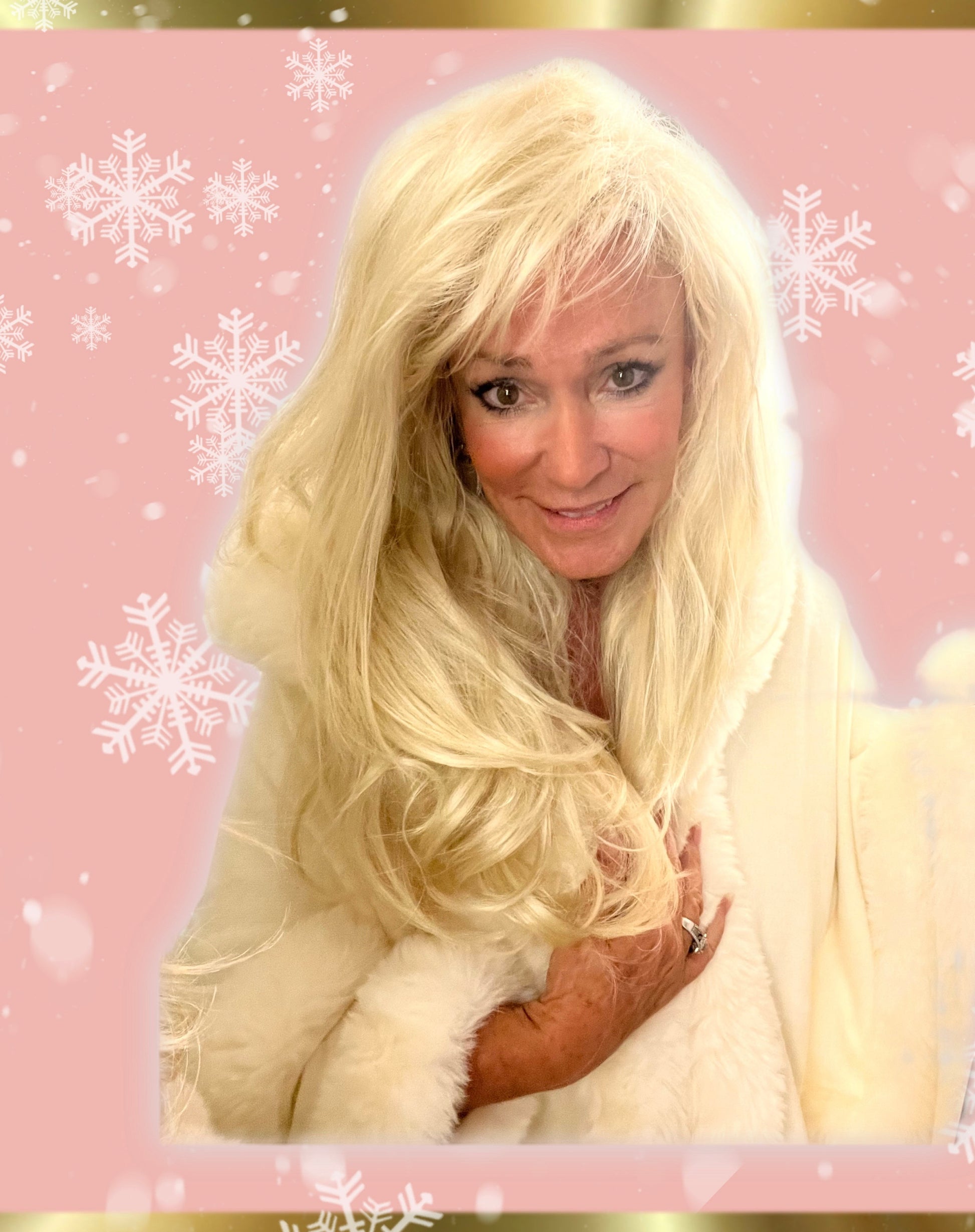 White hooded winter cape with plush fur trim worn by Linda Rick against a pink snowflake background