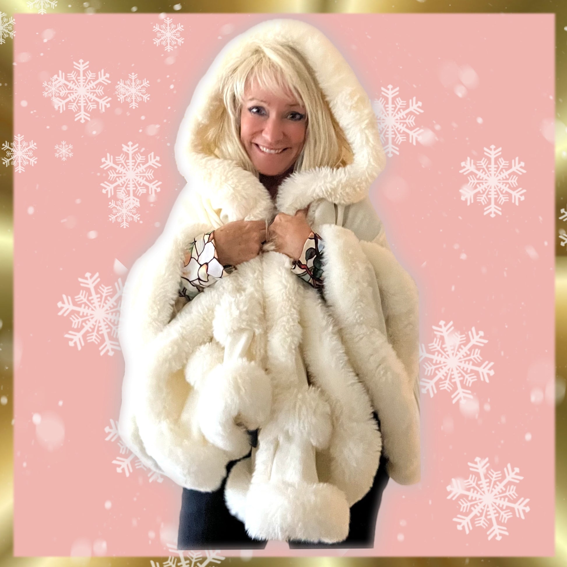 White hooded winter cape with plush fur trim worn by Linda Rick against a festive snowflake background.